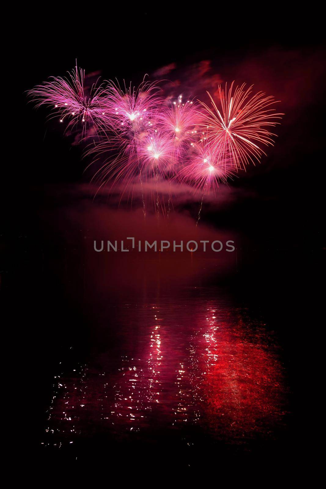 Beautiful colorful fireworks on the water surface with a clean black background. Fun festival and international contest of Firefighters from all over the world Ignis Brunensis 2017. Brno Dam - Czech Republic. by Montypeter