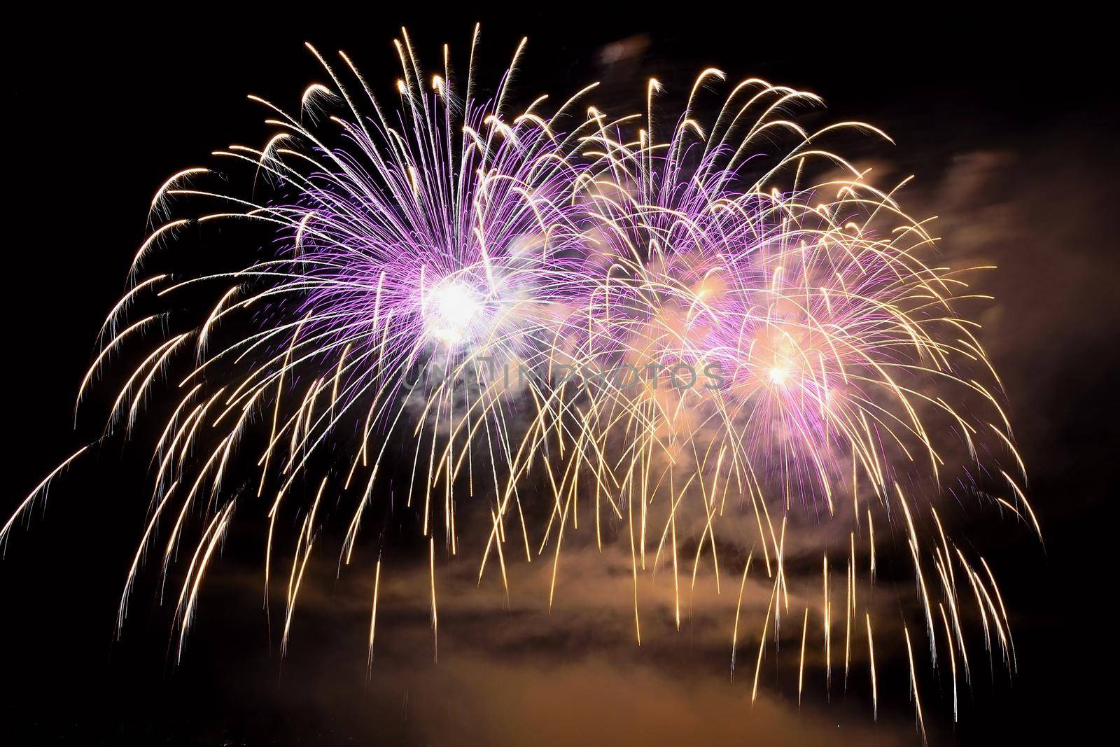 Beautiful colorful fireworks on the water surface with a clean black background. Fun festival and international contest of Firefighters from all over the world Ignis Brunensis 2017. Brno Dam - Czech Republic.