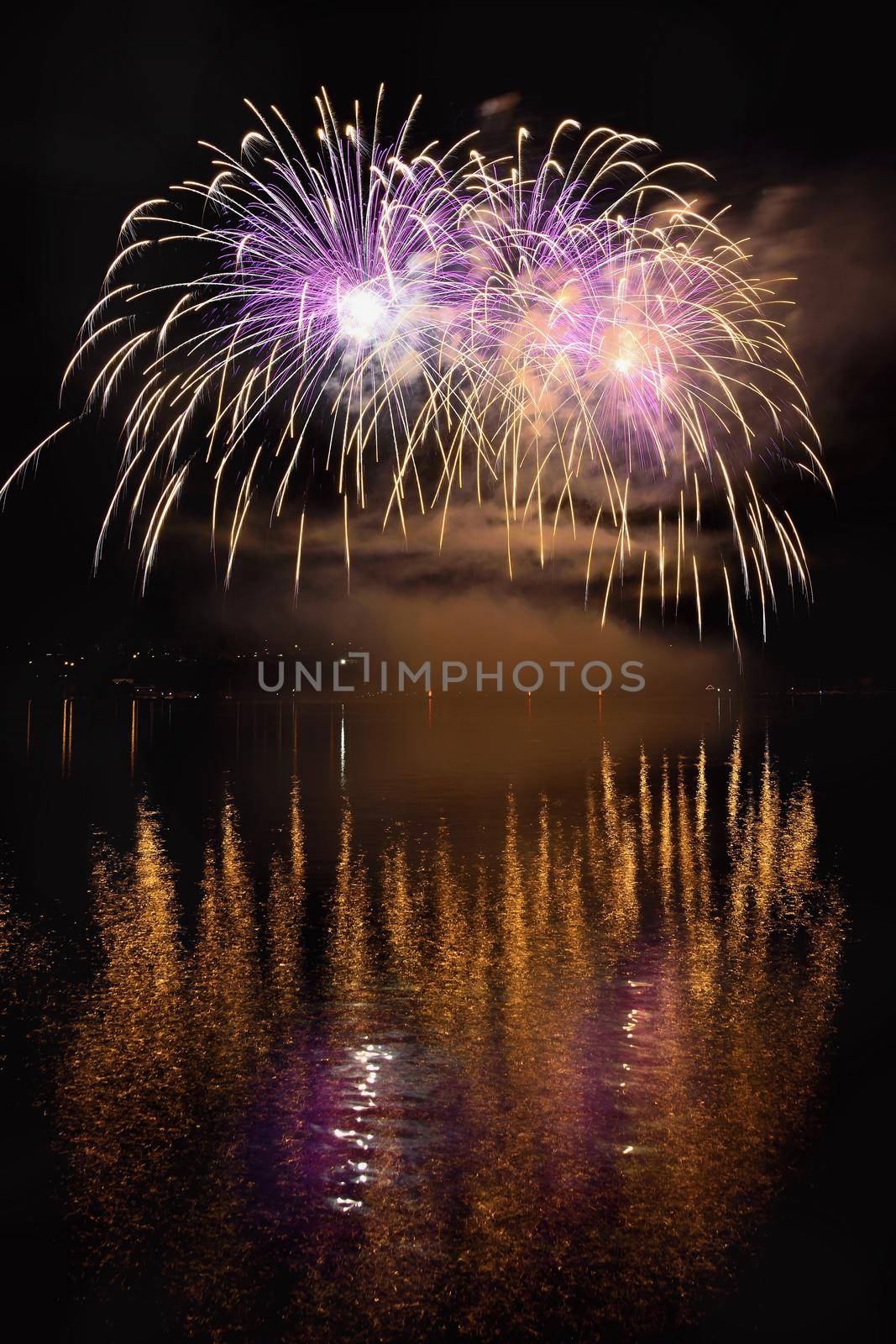 Beautiful colorful fireworks on the water surface with a clean black background. Fun festival and international contest of Firefighters from all over the world Ignis Brunensis 2017. Brno Dam - Czech Republic. by Montypeter