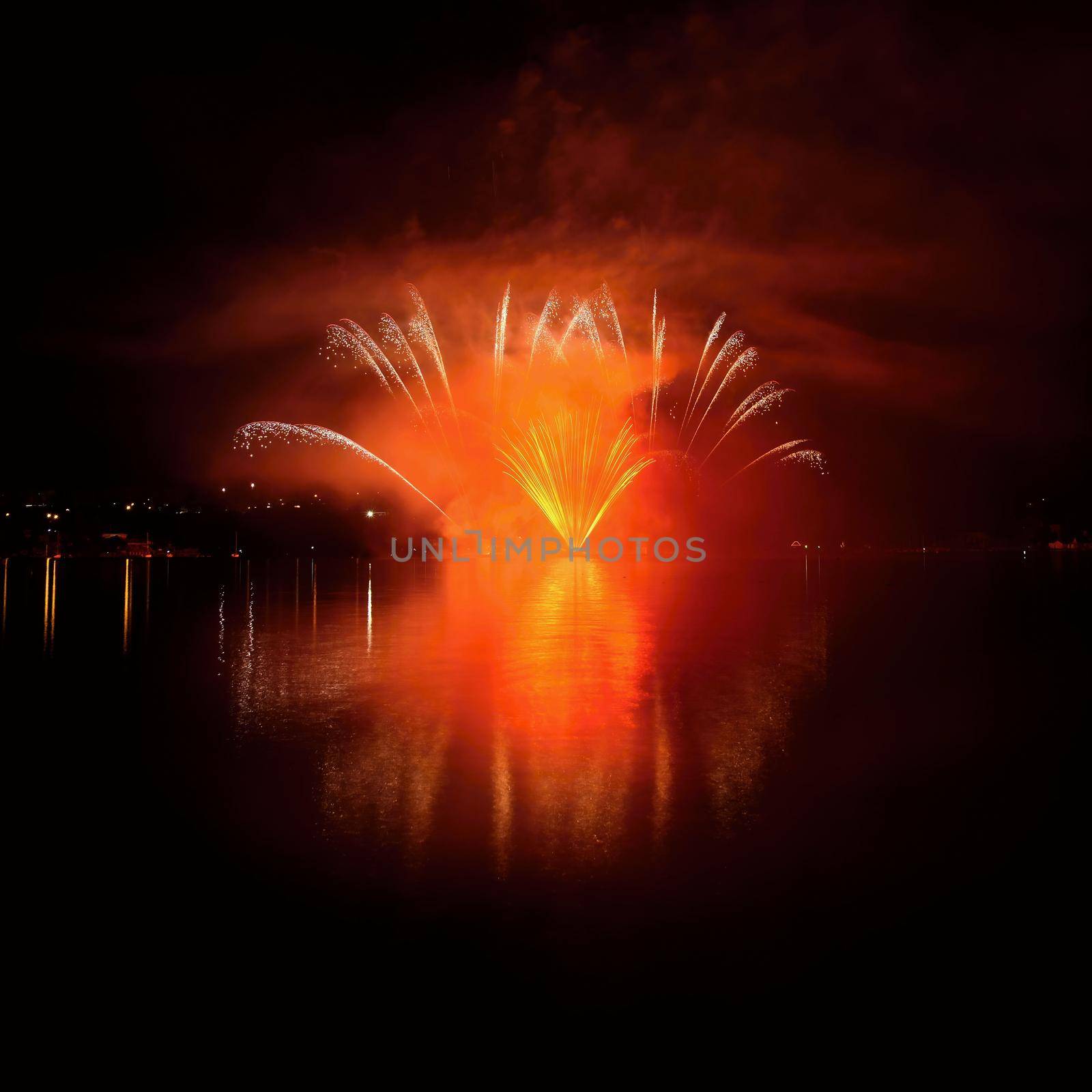 Beautiful colorful fireworks on the water surface with a clean black background. Fun festival and international contest of Firefighters from all over the world Ignis Brunensis 2017. Brno Dam - Czech Republic. by Montypeter