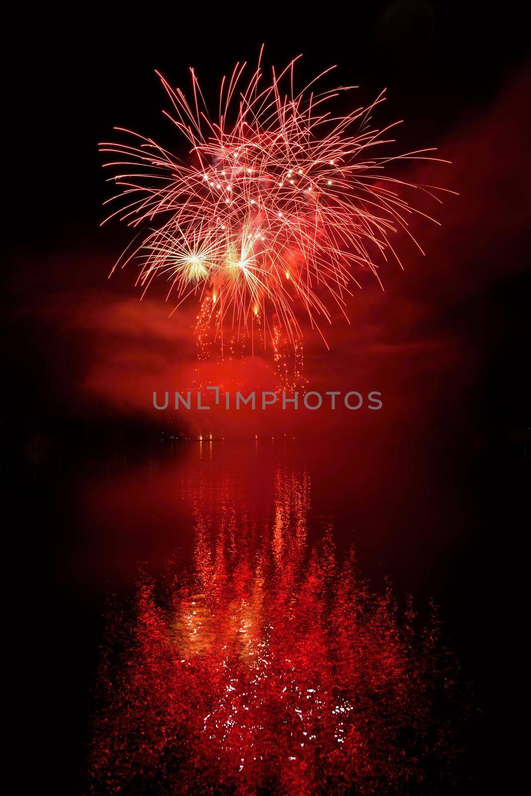 Beautiful colorful fireworks on the water surface with a clean black background. Fun festival and international contest of Firefighters from all over the world Ignis Brunensis 2017. Brno Dam - Czech Republic.