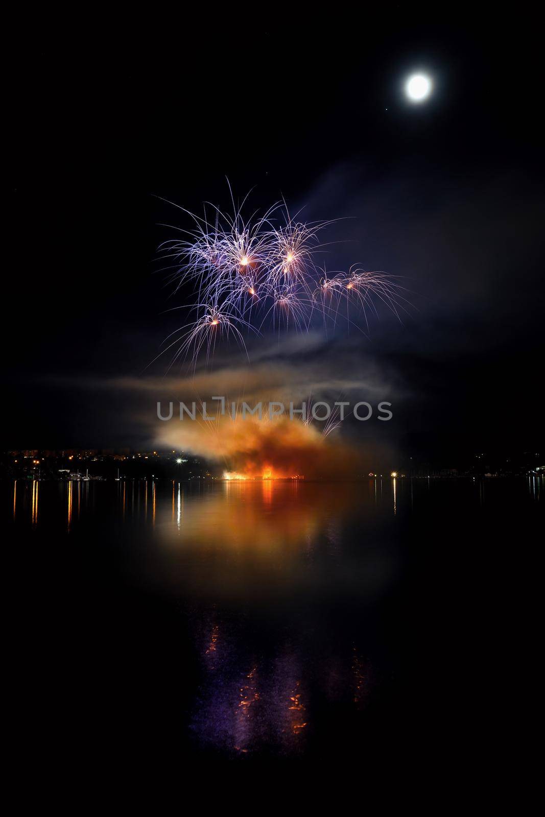 Beautiful colorful fireworks on the water surface with a clean black background. Fun festival and international contest of Firefighters from all over the world Ignis Brunensis 2017. Brno Dam - Czech Republic. by Montypeter