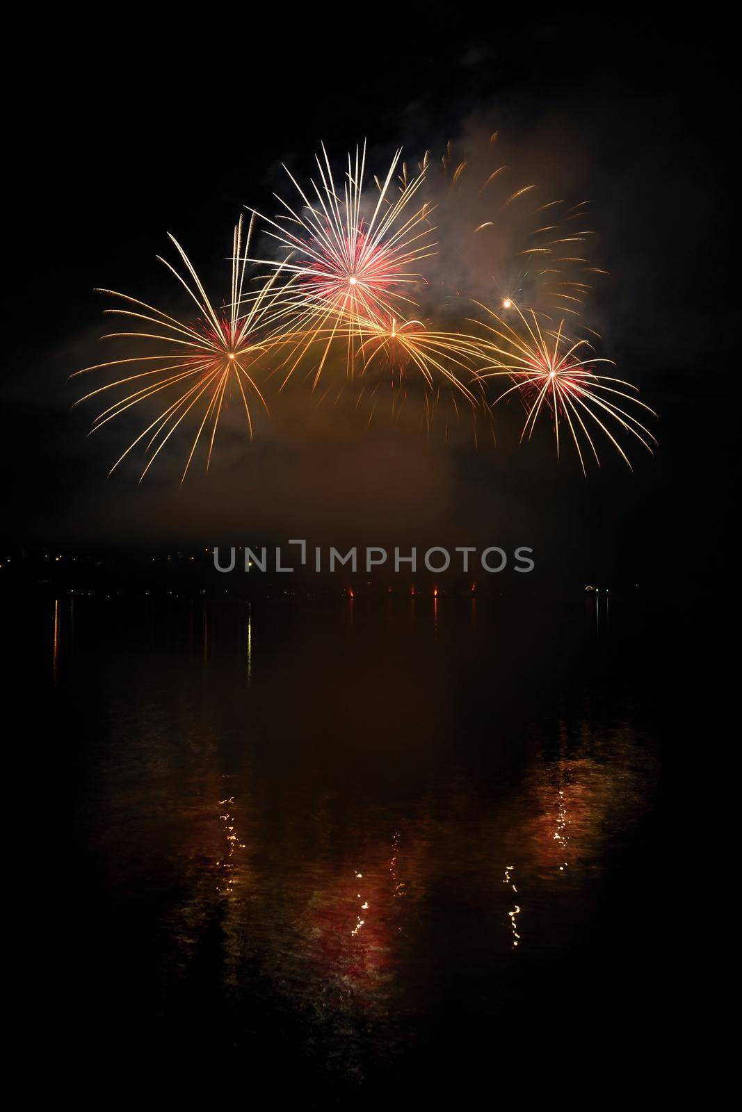 Beautiful colorful fireworks on the water surface with a clean black background. Fun festival and international contest of Firefighters from all over the world Ignis Brunensis 2017. Brno Dam - Czech Republic. by Montypeter