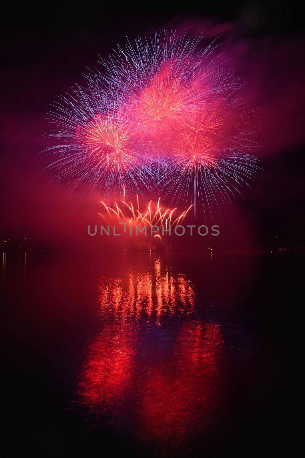 Beautiful colorful fireworks on the water surface with a clean black background. Fun festival and international contest of Firefighters from all over the world Ignis Brunensis 2017. Brno Dam - Czech Republic. by Montypeter