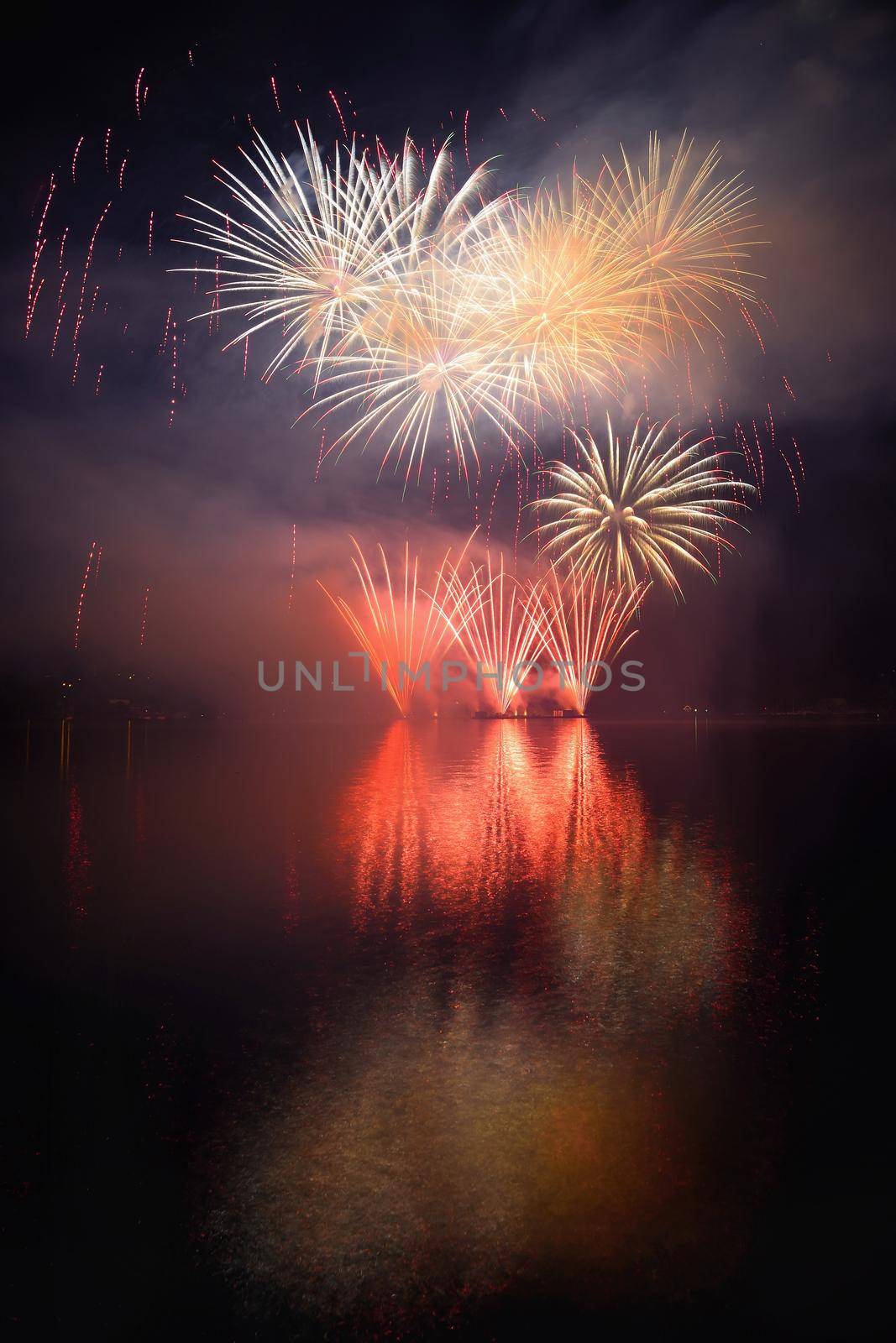 Beautiful colorful fireworks on the water surface with a clean black background. Fun festival and international contest of Firefighters from all over the world Ignis Brunensis 2017. Brno Dam - Czech Republic. by Montypeter