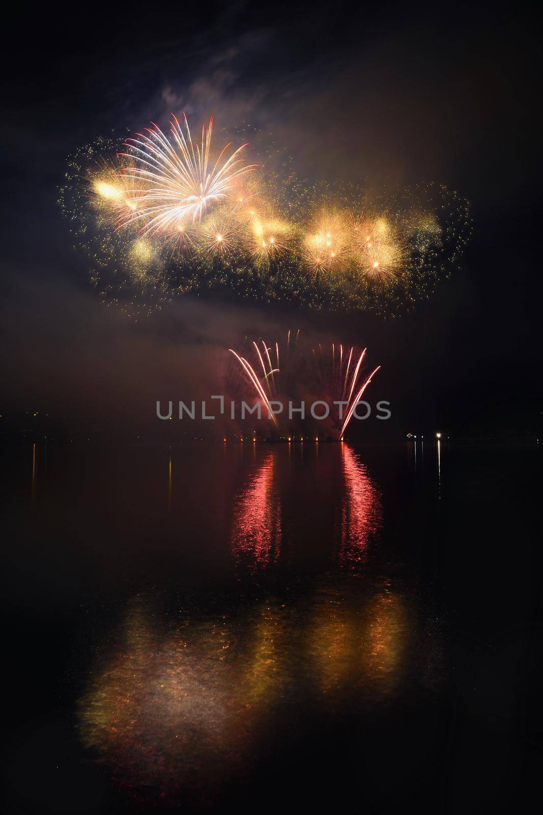 Beautiful colorful fireworks on the water surface with a clean black background. Fun festival and international contest of Firefighters from all over the world Ignis Brunensis 2017. Brno Dam - Czech Republic. by Montypeter