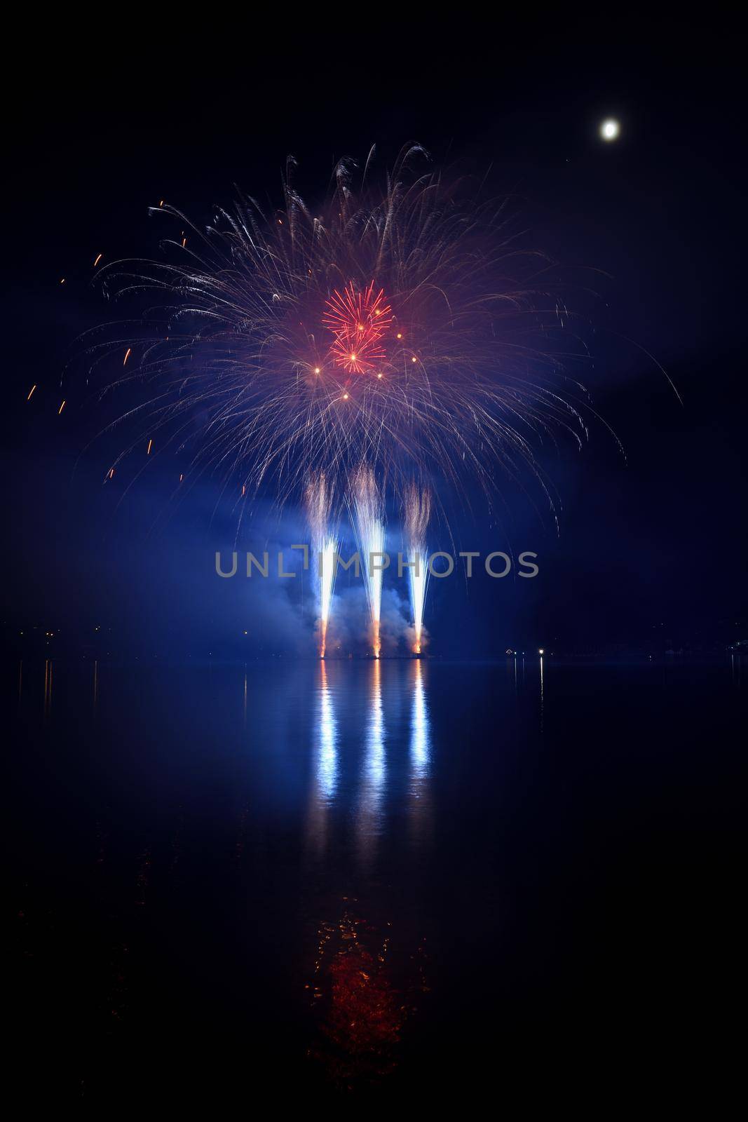 Firework. Beautiful colorful fireworks on the water surface with a clean black background. Fun festival and contest of Firefighters  Brno Dam - Czech Republic.