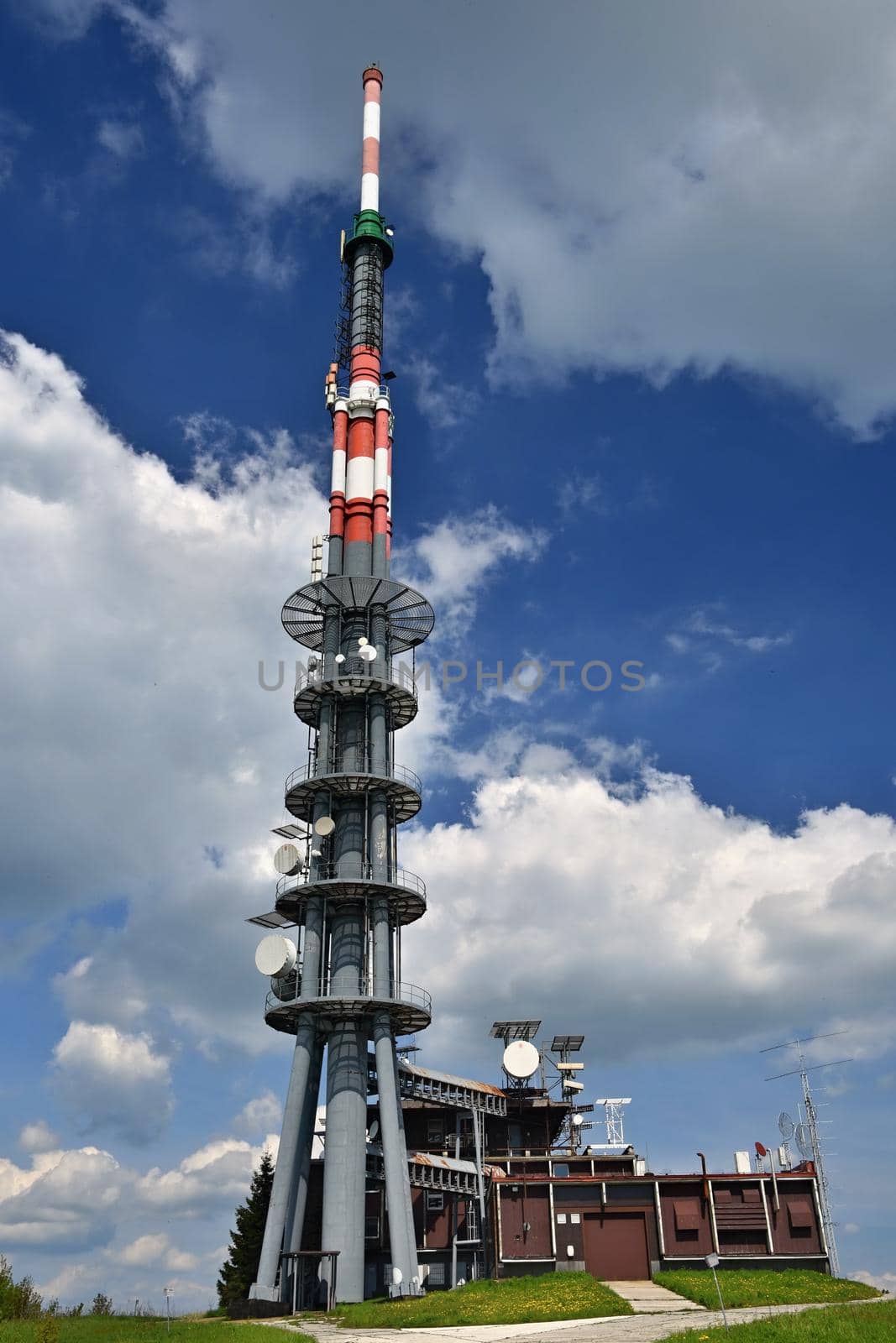 The transmitter on top of the mountain. Velka Javorina. Czech-Slovak Republic, Europe. Sky with clouds. Beautiful blue natural background. by Montypeter