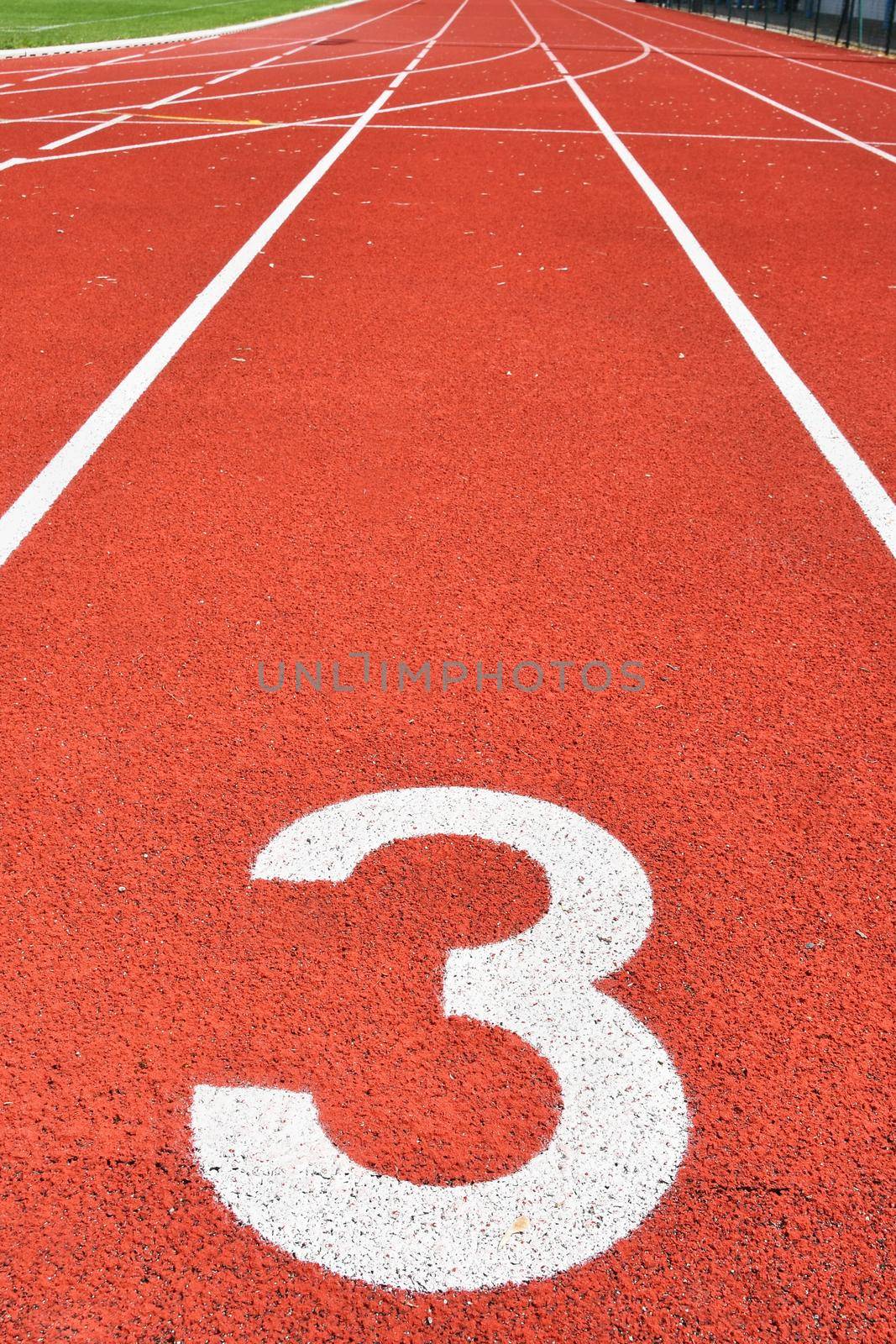 Running track with number 3. Colorful background for sport. by Montypeter