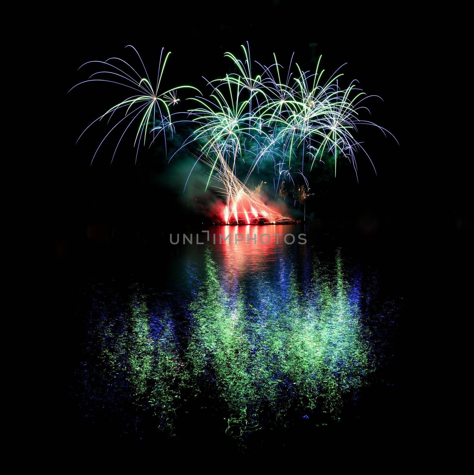 Firework. Beautiful colorful fireworks on the water surface with a clean black background. Fun festival and contest of Firefighters  Brno Dam - Czech Republic. by Montypeter