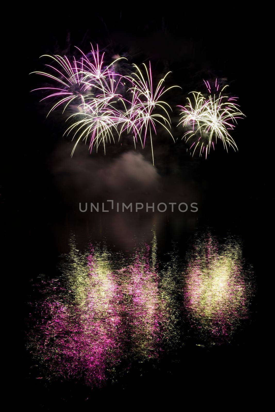 Firework. Beautiful colorful fireworks on the water surface with a clean black background. Fun festival and contest of Firefighters  Brno Dam - Czech Republic. by Montypeter