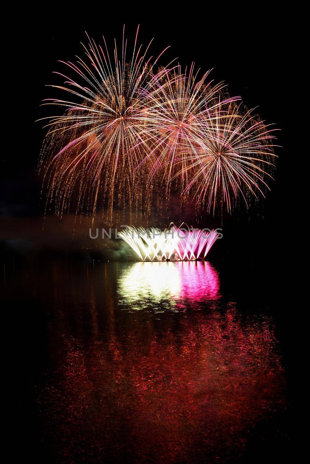 Firework. Beautiful colorful fireworks on the water surface with a clean black background. Fun festival and contest of Firefighters  Brno Dam - Czech Republic. by Montypeter