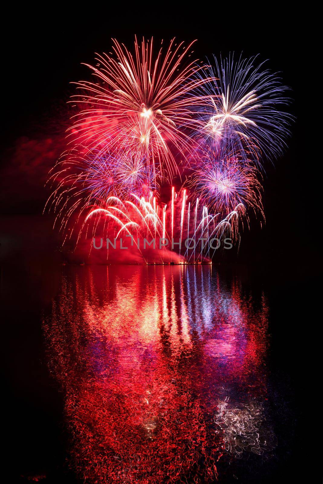 Firework. Beautiful colorful fireworks on the water surface with a clean black background. Fun festival and contest of Firefighters  Brno Dam - Czech Republic. by Montypeter