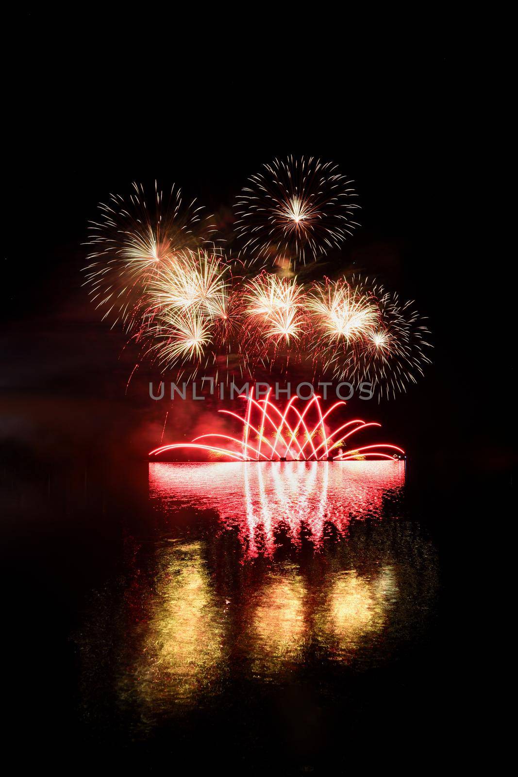 Firework. Beautiful colorful fireworks on the water surface with a clean black background. Fun festival and contest of Firefighters  Brno Dam - Czech Republic. by Montypeter