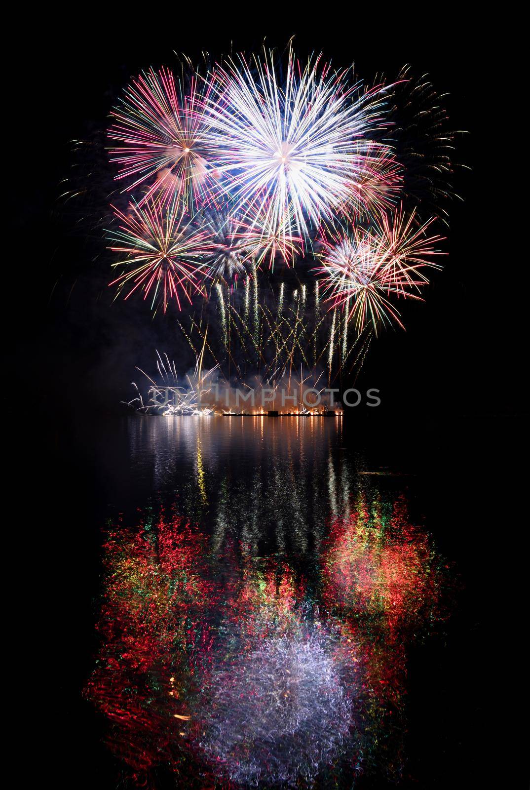 Firework. Beautiful colorful fireworks on the water surface with a clean black background. Fun festival and contest of Firefighters  Brno Dam - Czech Republic.