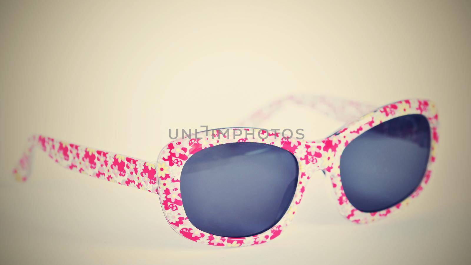 Sunglasses. Baby, pink-white colorful glasses isolated on a clean white background.