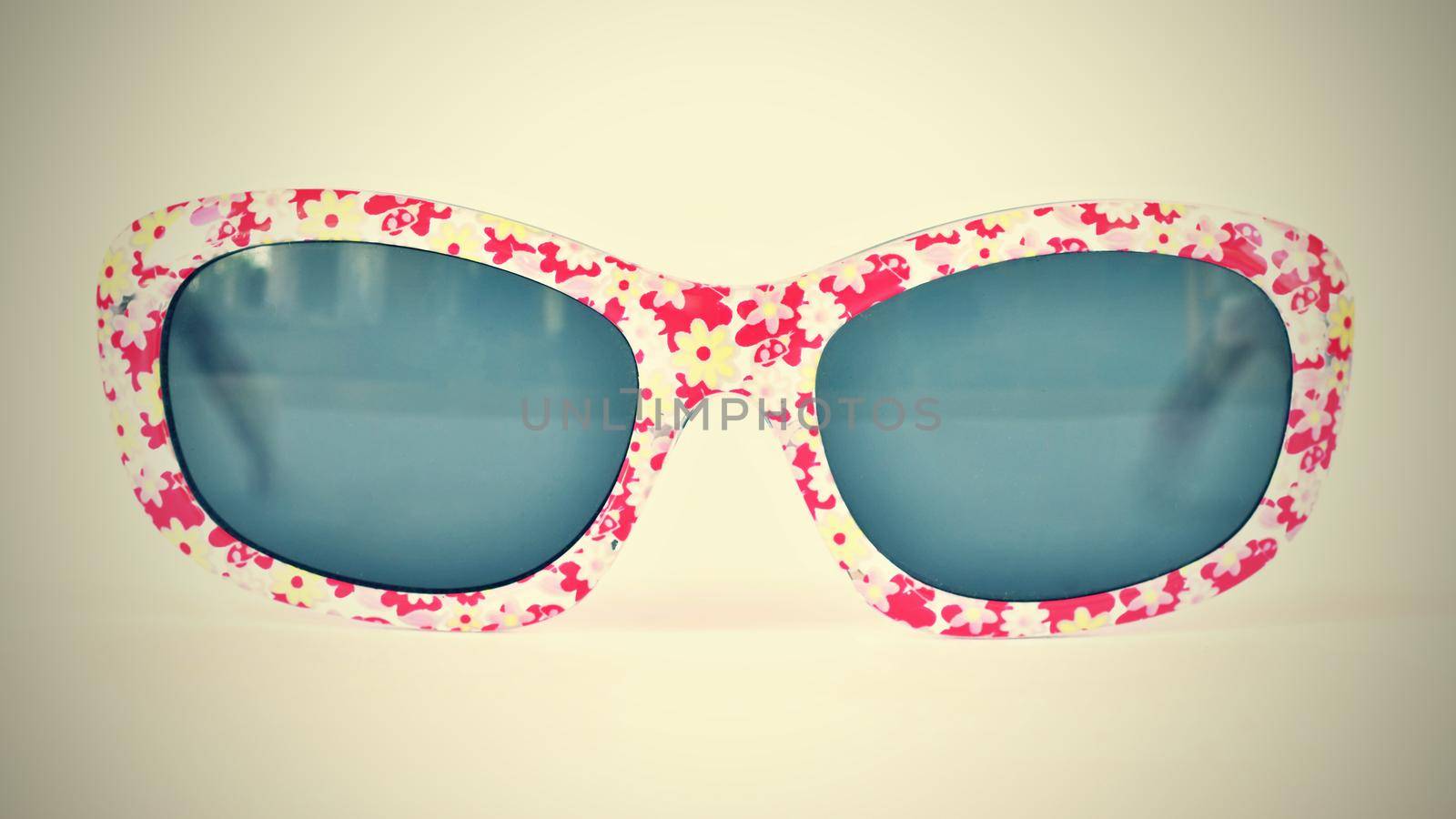 Sunglasses. Baby, pink-white colorful glasses isolated on a clean white background.