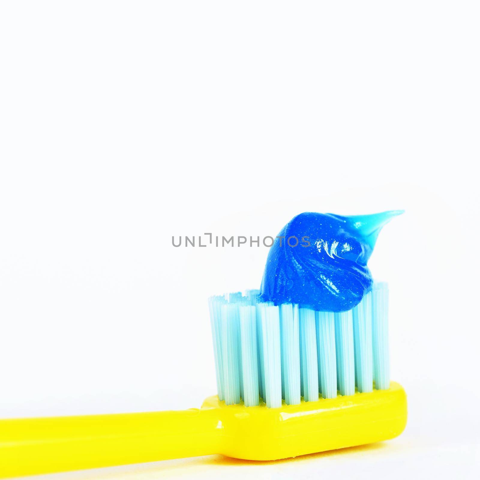 Toothbrush with paste on a white background. by Montypeter