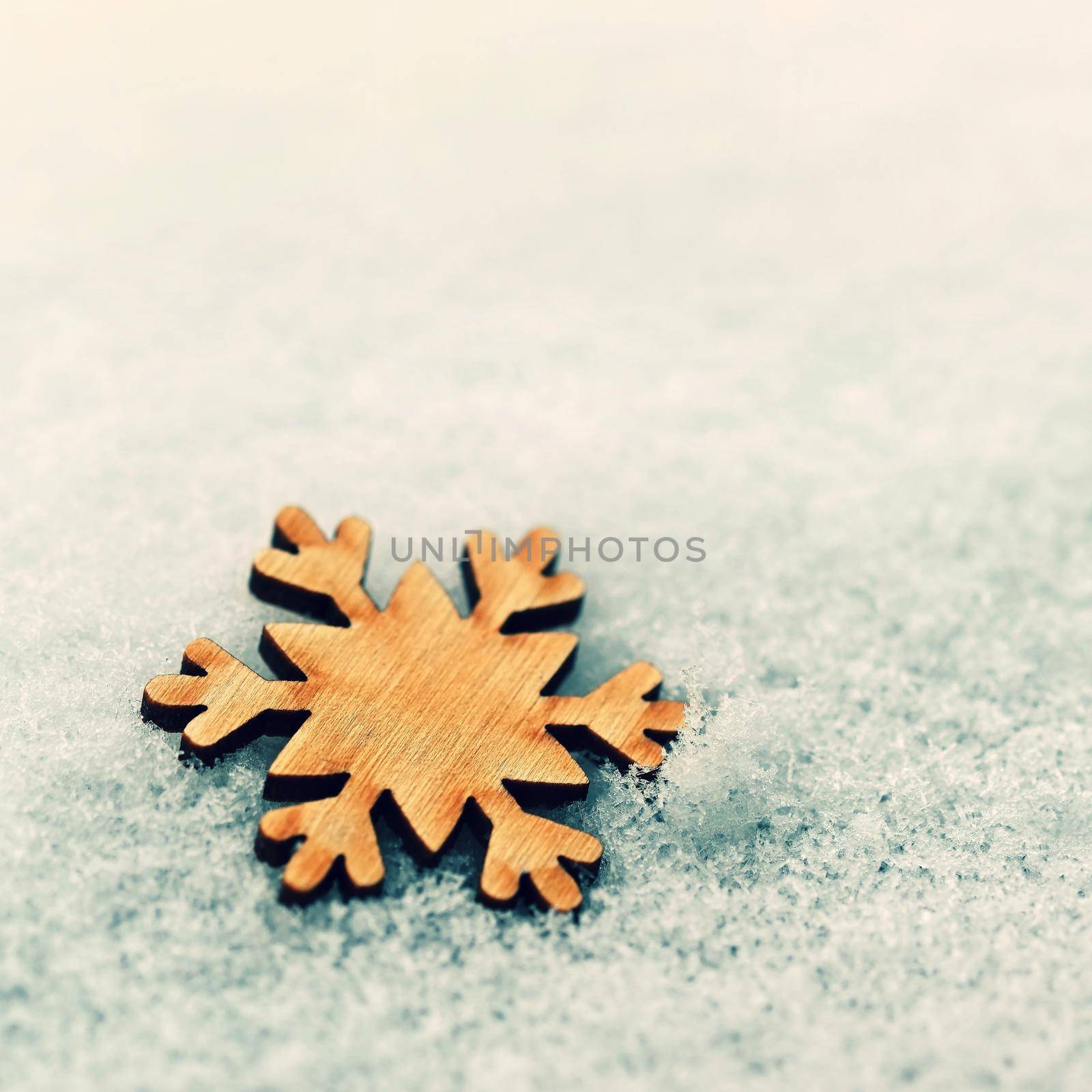 Christmas background. Christmas tree decoration - beautiful natural wooden snowflake with real snow. Background for winter and holiday. 