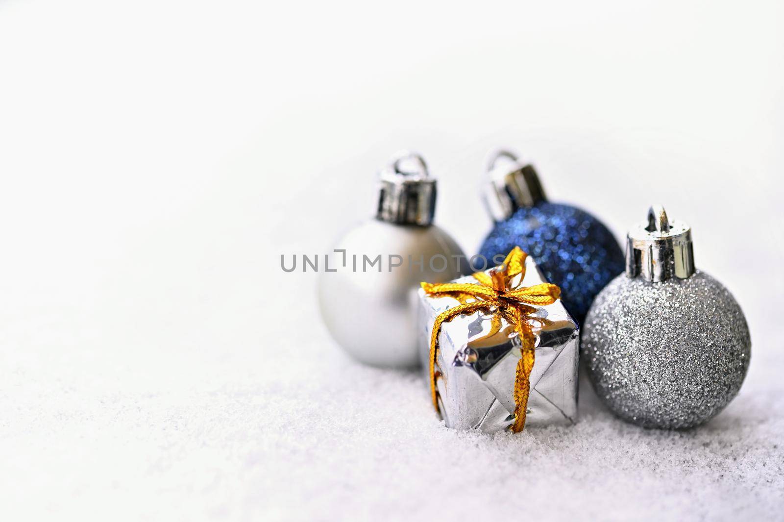 Christmas background. Beautiful decorations for the Christmas tree on real snow. Objects for the holidays and winter time.