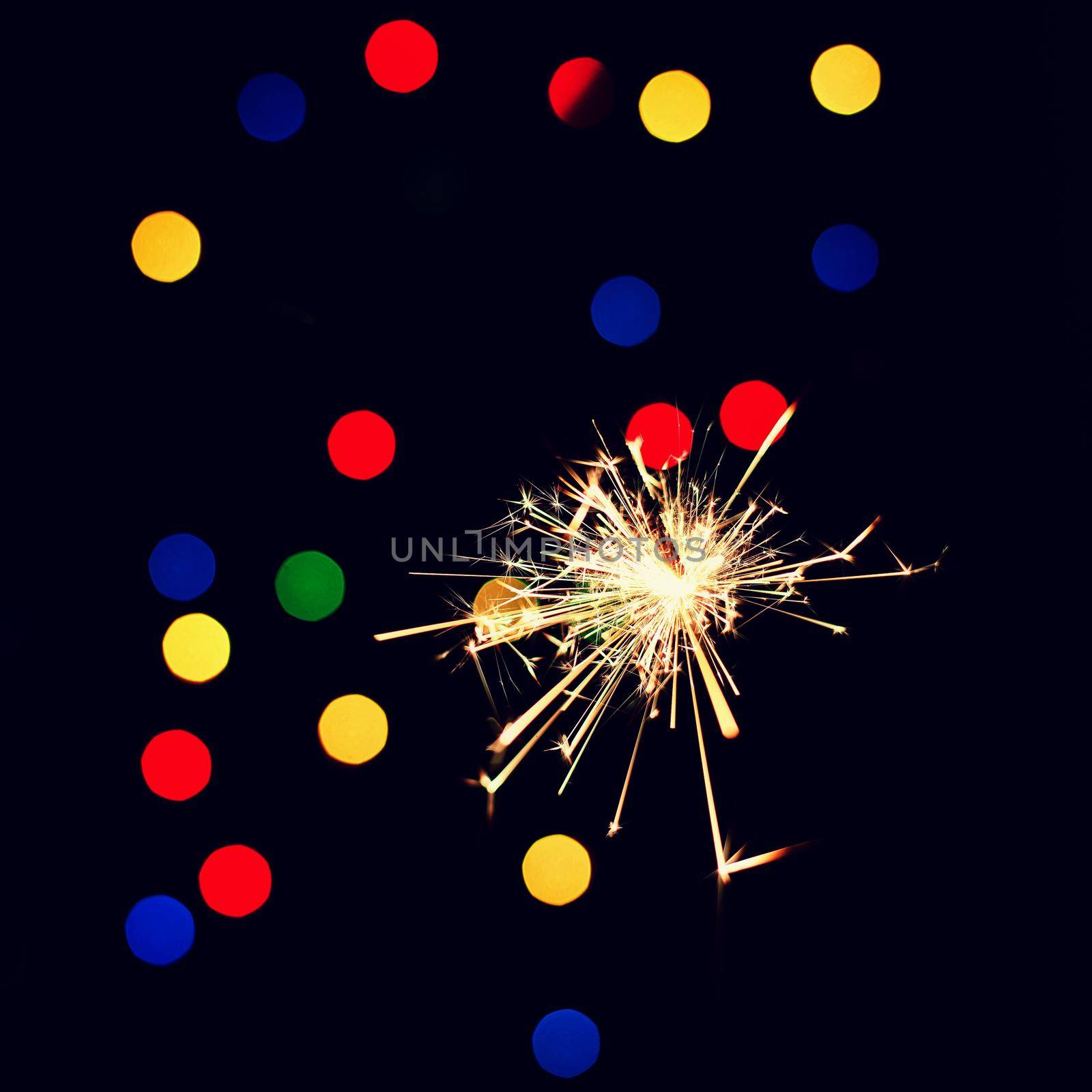 Sparkler with beautiful abstract colorful background. Concept for Christmas and Happy New Year 2021. by Montypeter