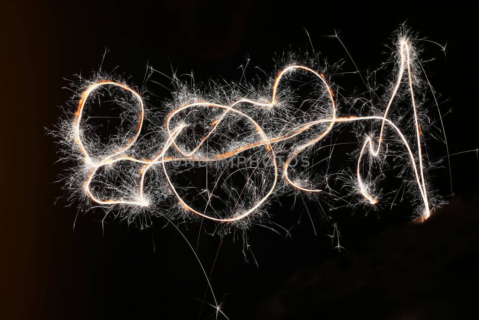 Sparkler - beautiful abstract background. Concept for Christmas and Happy New Year 2021.
