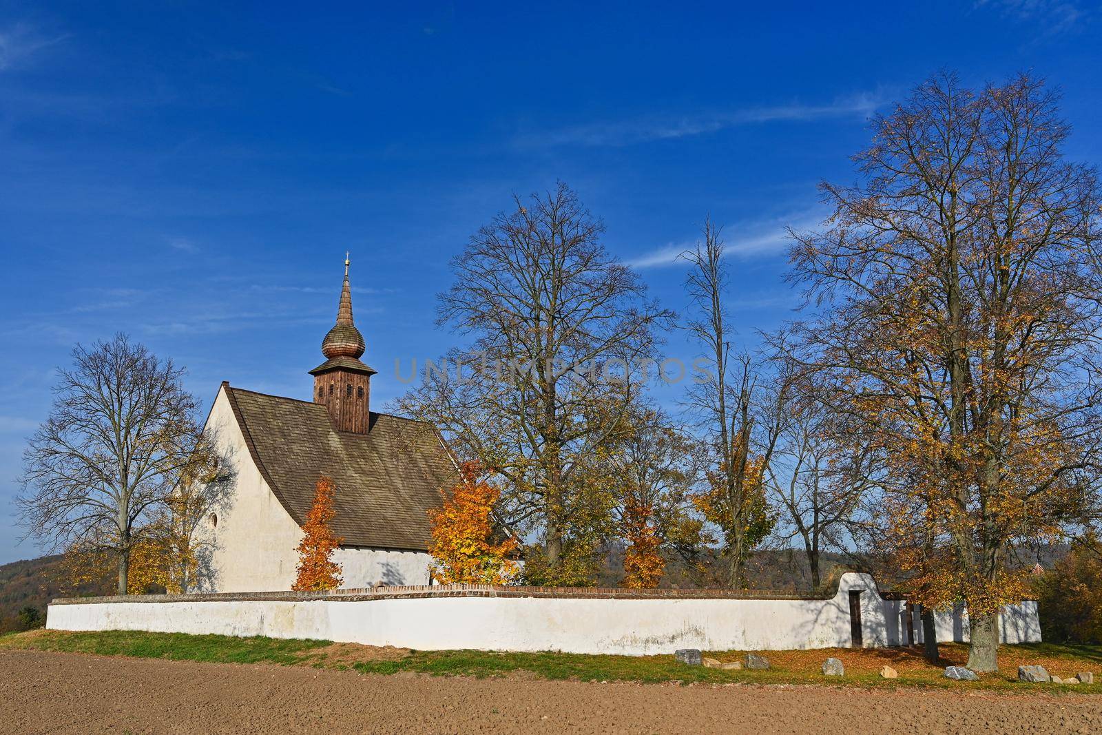 Beautiful autumn landscape with old Chapel of the Mother of God in Veveří. Sunset and beautiful blue sky with clouds. Colorful nature background on autumn season. Brno - Czech Republic.