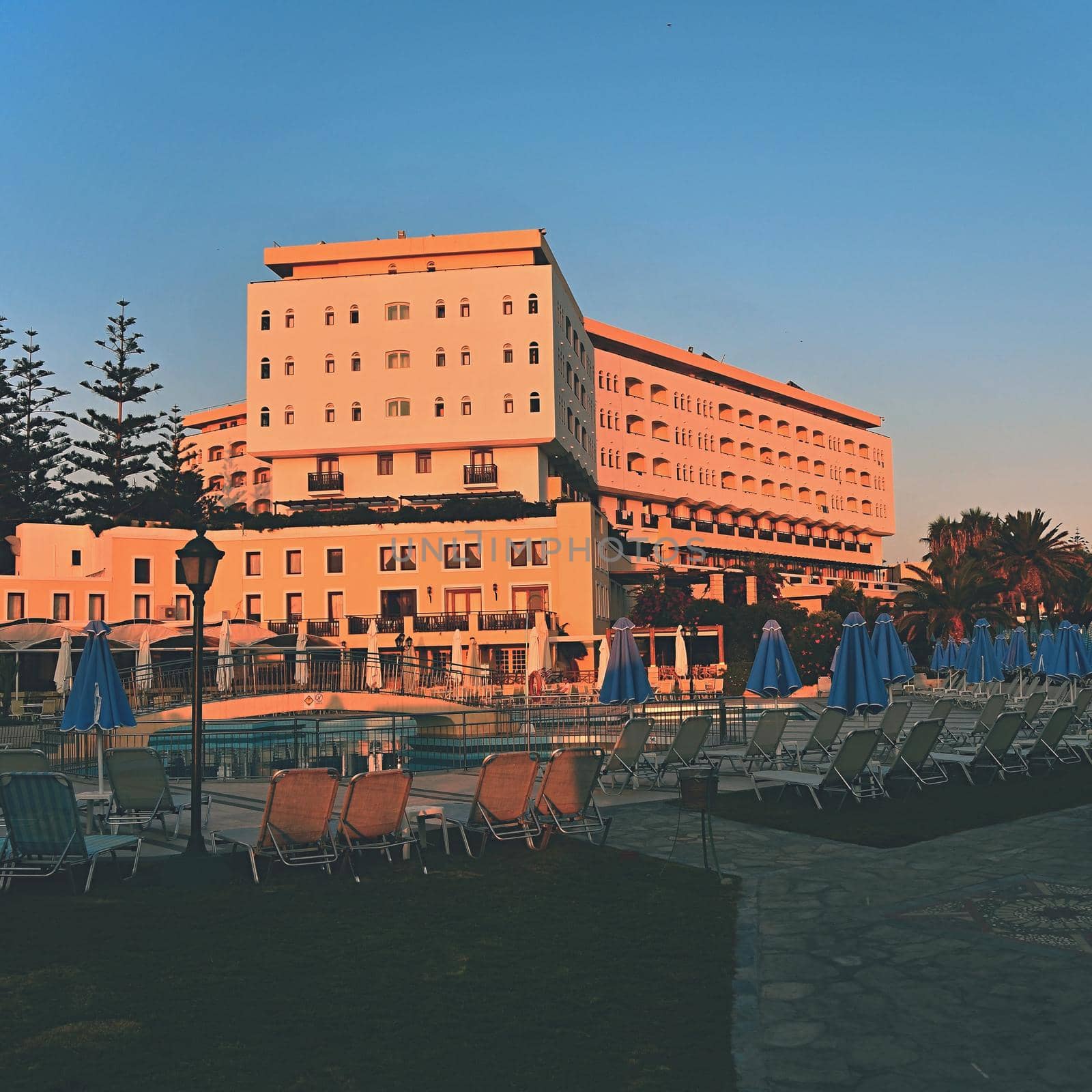 Beautiful hotel - beach resort at sunset. Summer background for travel and holidays. Greece Crete. by Montypeter
