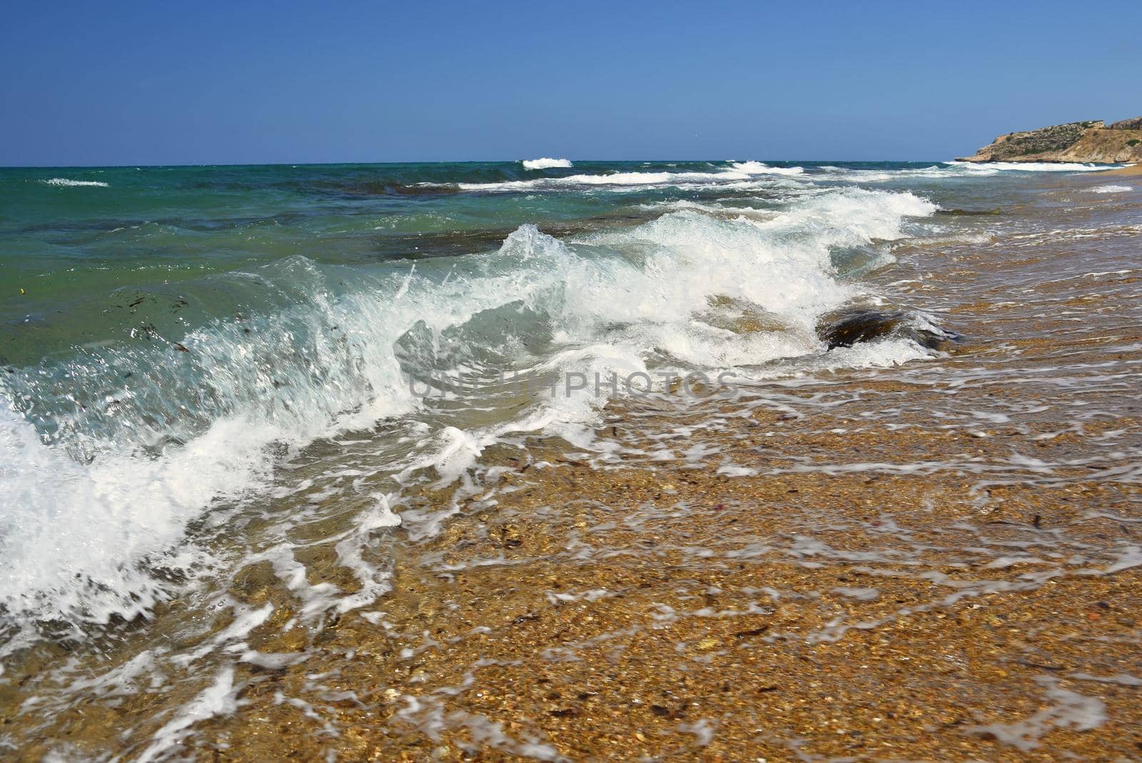 Beautiful clean sea and waves. Summer background for travel and holidays. Greece Crete.. Amazing scenery on the beach. 