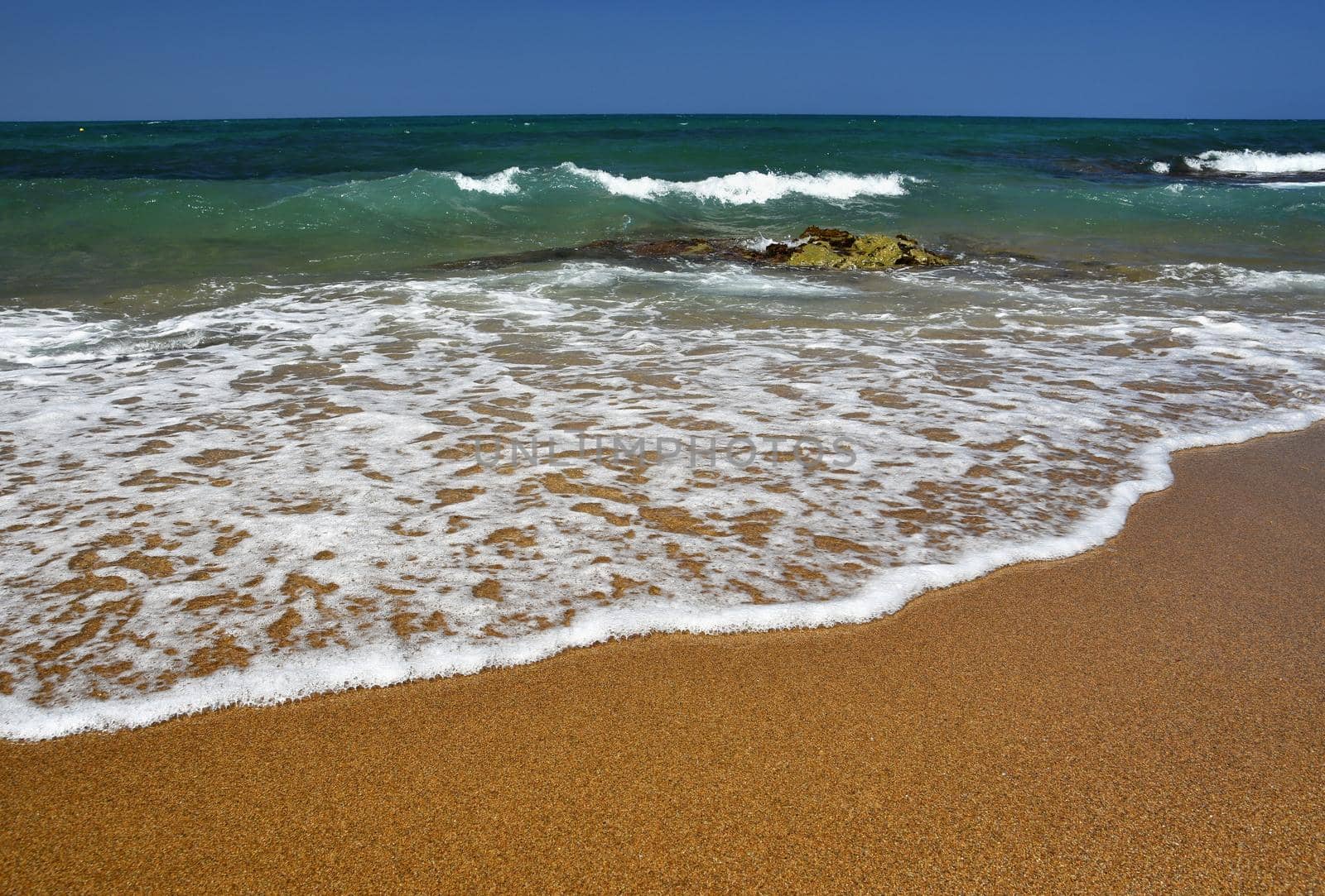 Beautiful clean sea and waves. Summer background for travel and holidays. Greece Crete.. Amazing scenery on the beach. 