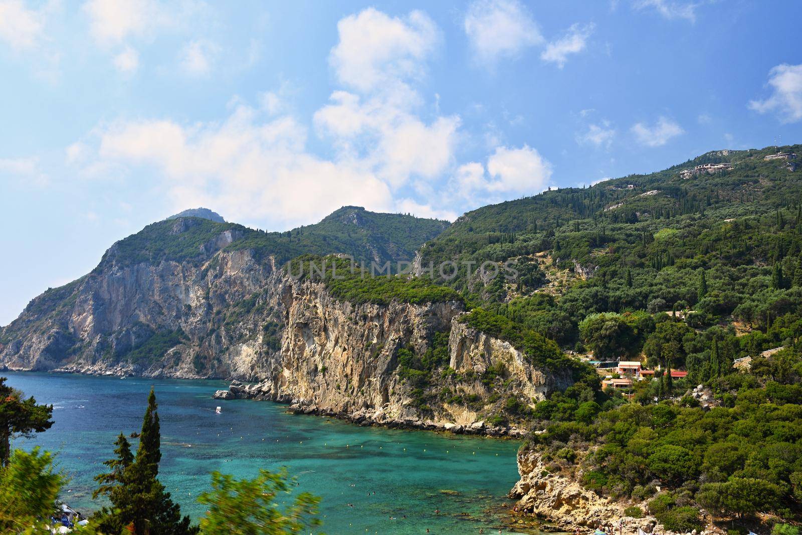 Beautiful beach and boats. Clean sea with a bay. Concept for travel, vacation and tourism. Great place for summer holidays and swimming. Paleokastritsa, Corfu island, Greece.