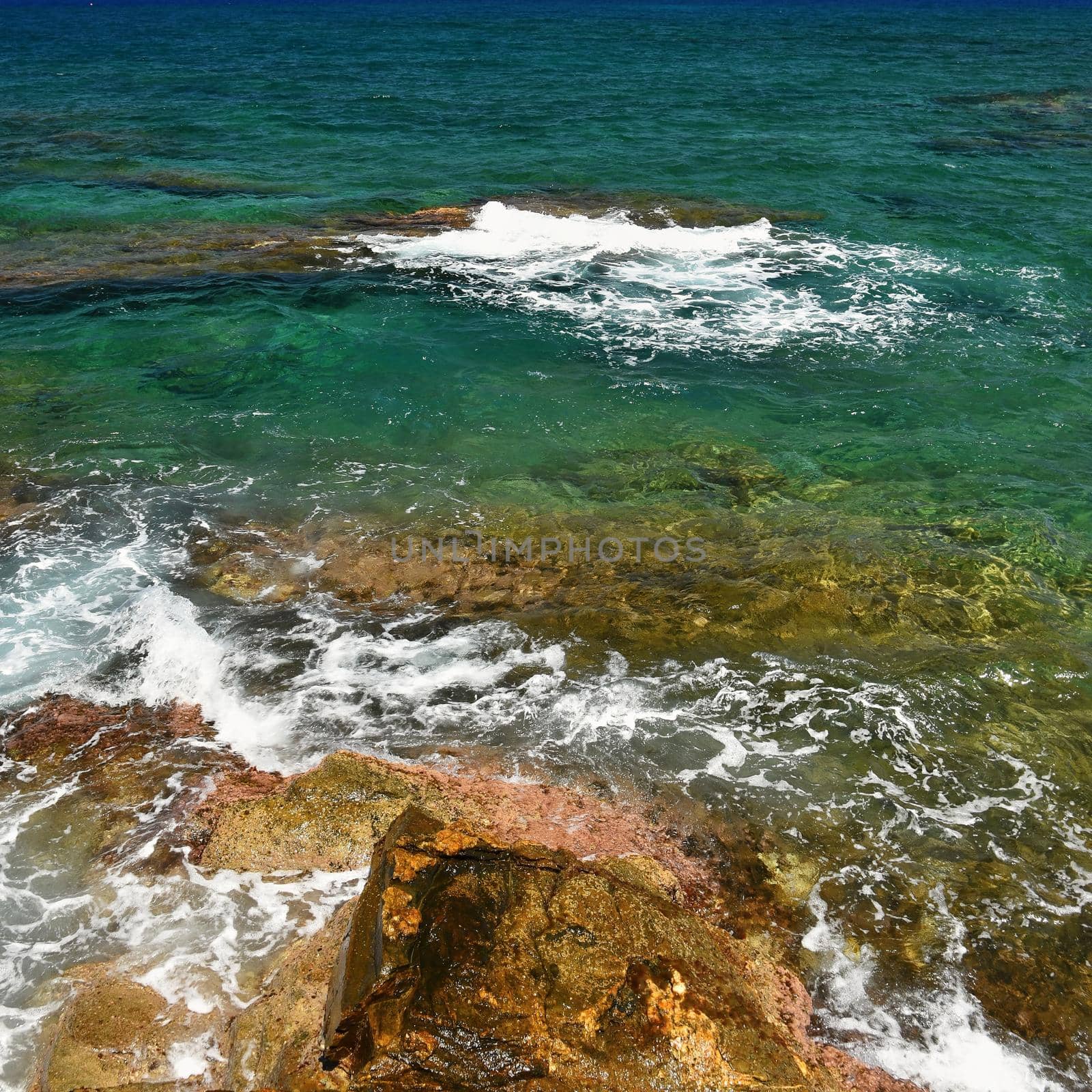 Beautiful clean sea and waves. Summer background for travel and holidays. Greece Crete.. Amazing scenery on the beach.  by Montypeter