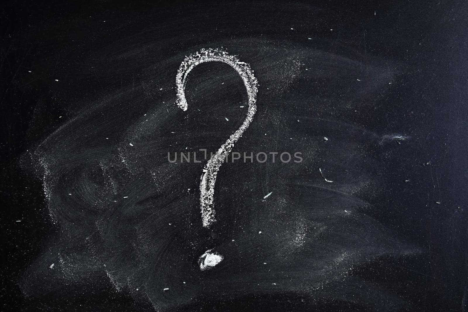 Question mark drawn in chalk on a blackboard.