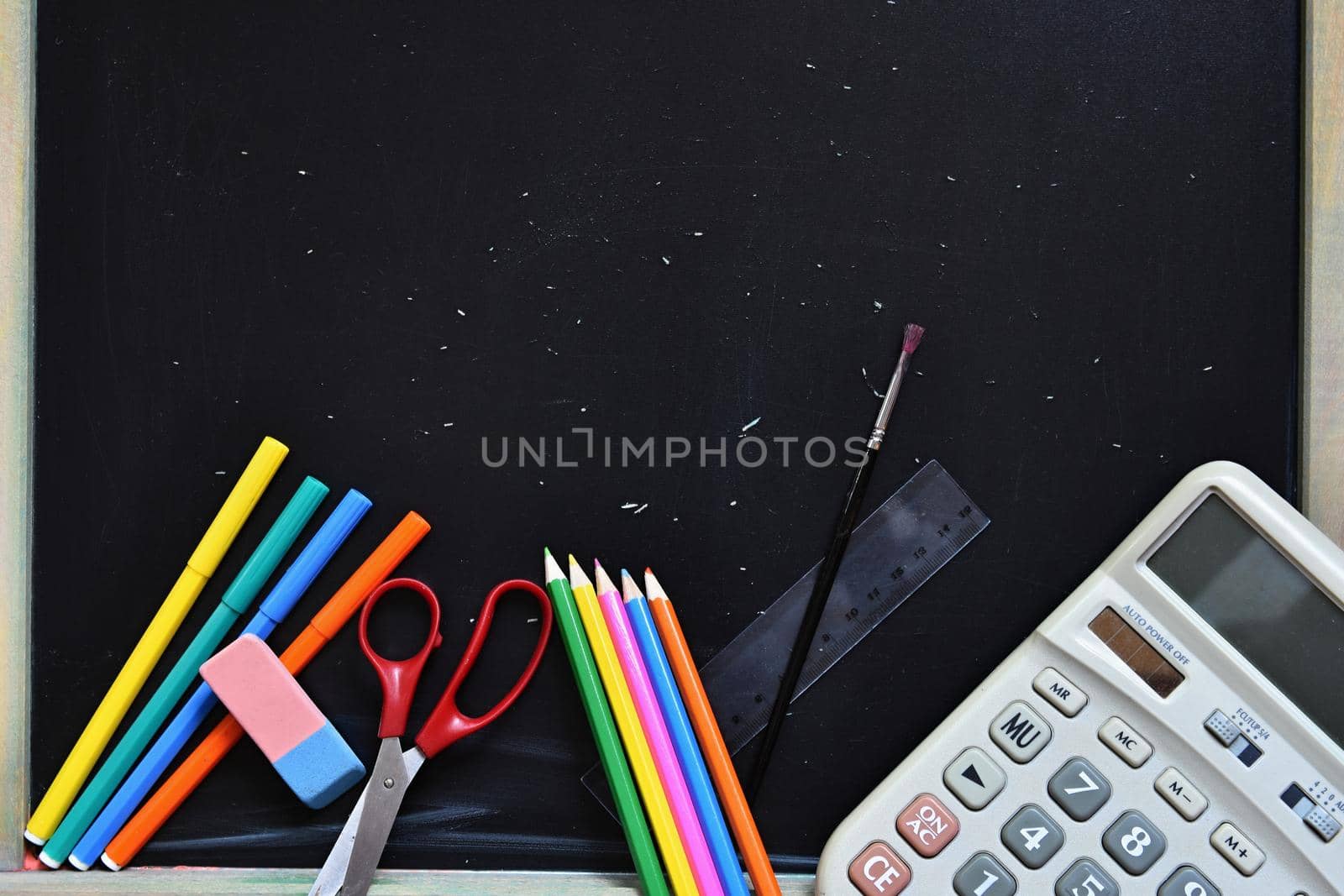Background back to school. Blackboard with school aids.