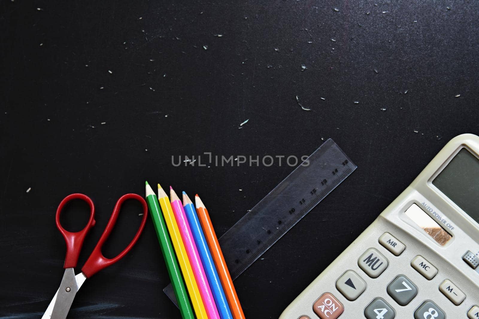 Background back to school. Blackboard with school aids.