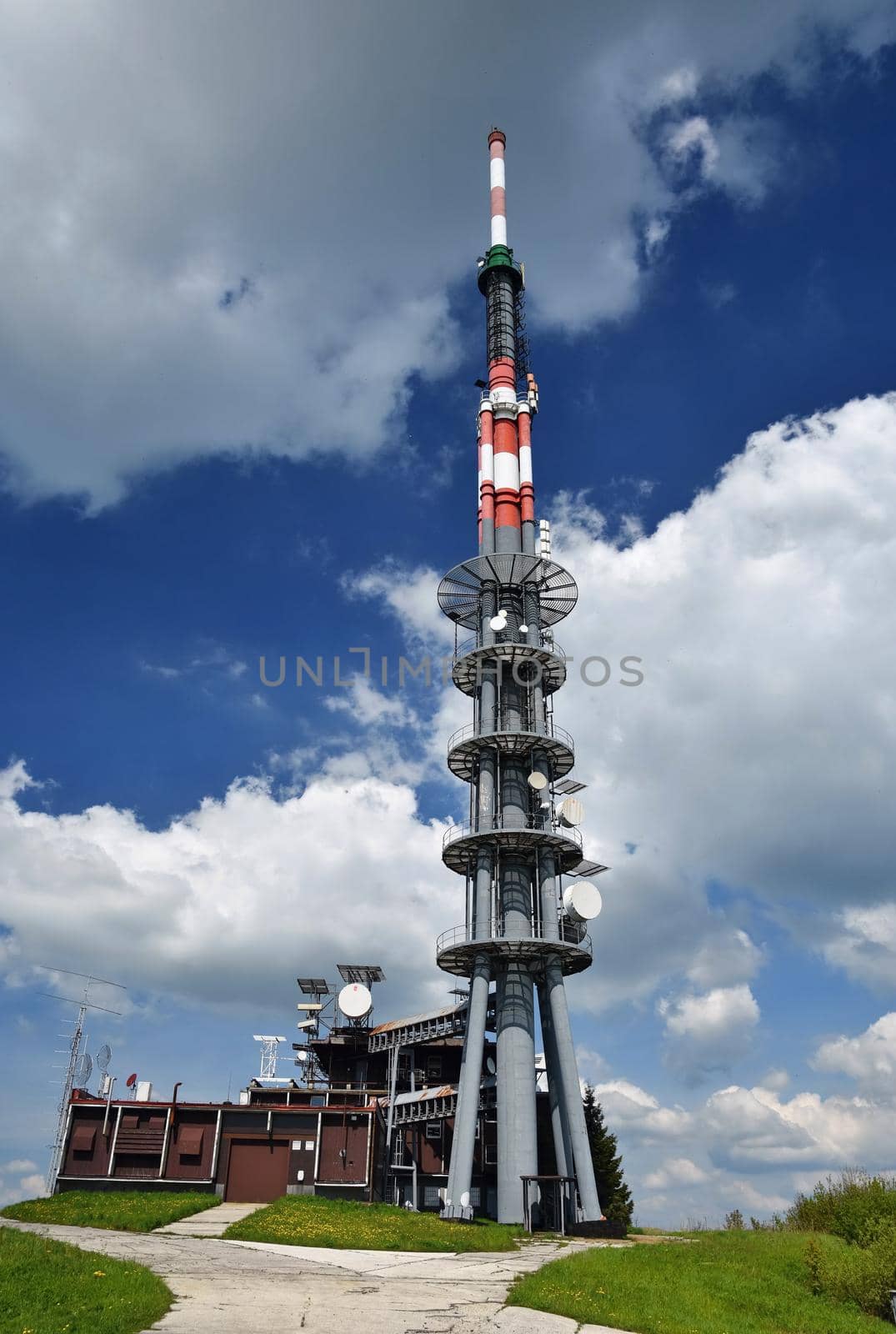 The transmitter on top of the mountain. Velka Javorina. Czech-Slovak Republic, Europe. Sky with clouds. Beautiful blue natural background. by Montypeter