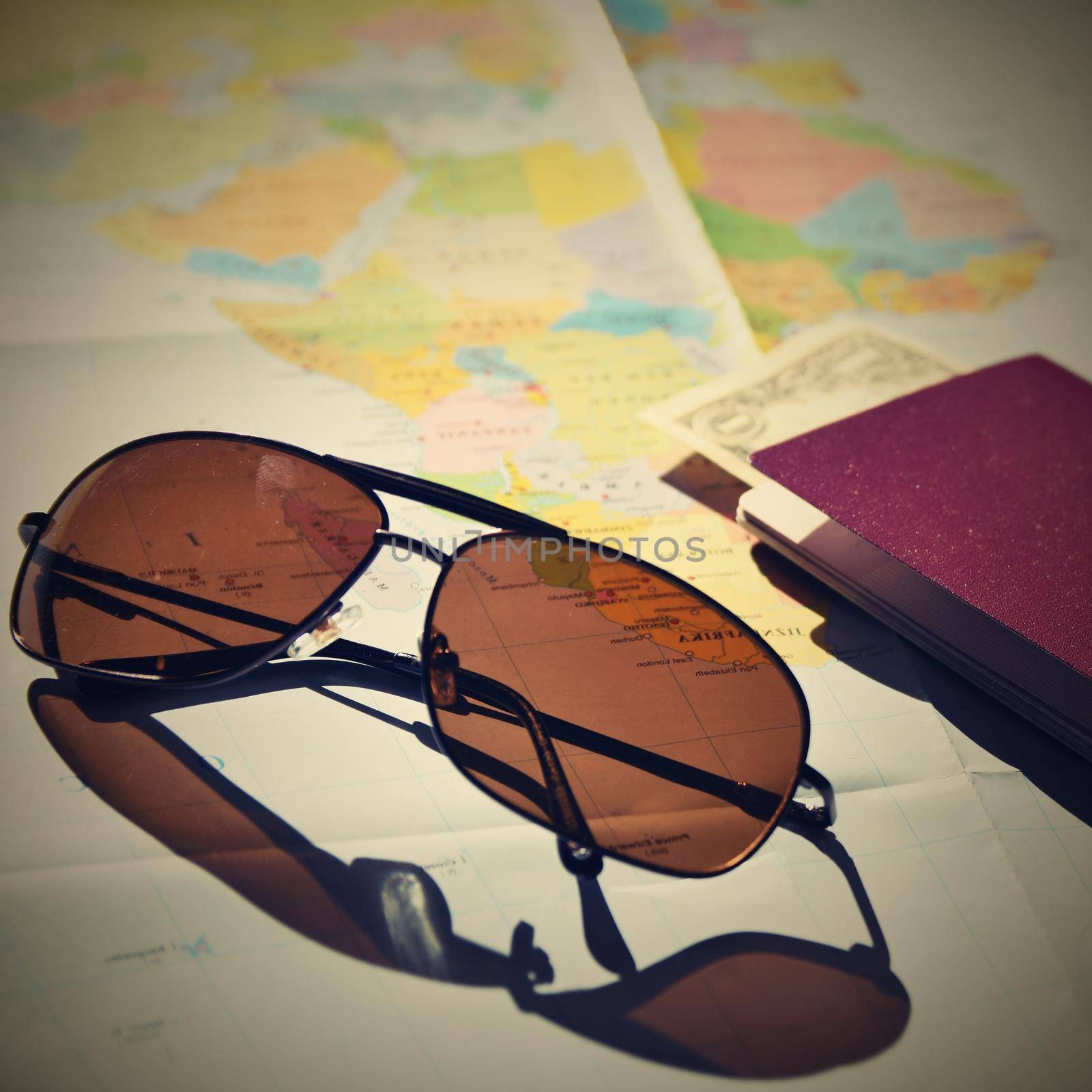 Beautiful concept for summer travel. Sunglasses with passport. Planning a summer vacation and holidays. by Montypeter