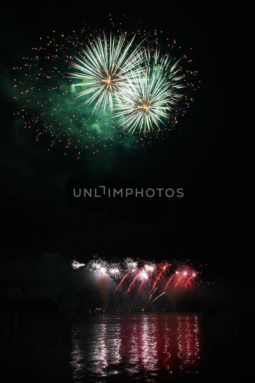 Beautiful colorful fireworks on water. Brno dam. International Fireworks Competition Ignis Brunensis. Brno - Czech Republic - Europe. by Montypeter