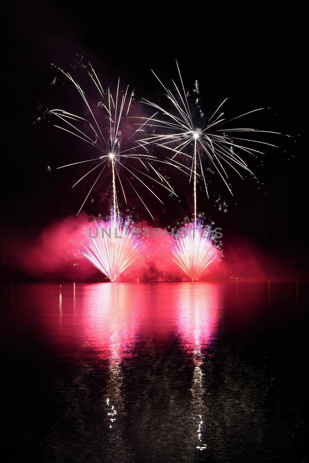 Beautiful colorful fireworks on water. Brno dam. International Fireworks Competition Ignis Brunensis. Brno - Czech Republic - Europe. by Montypeter