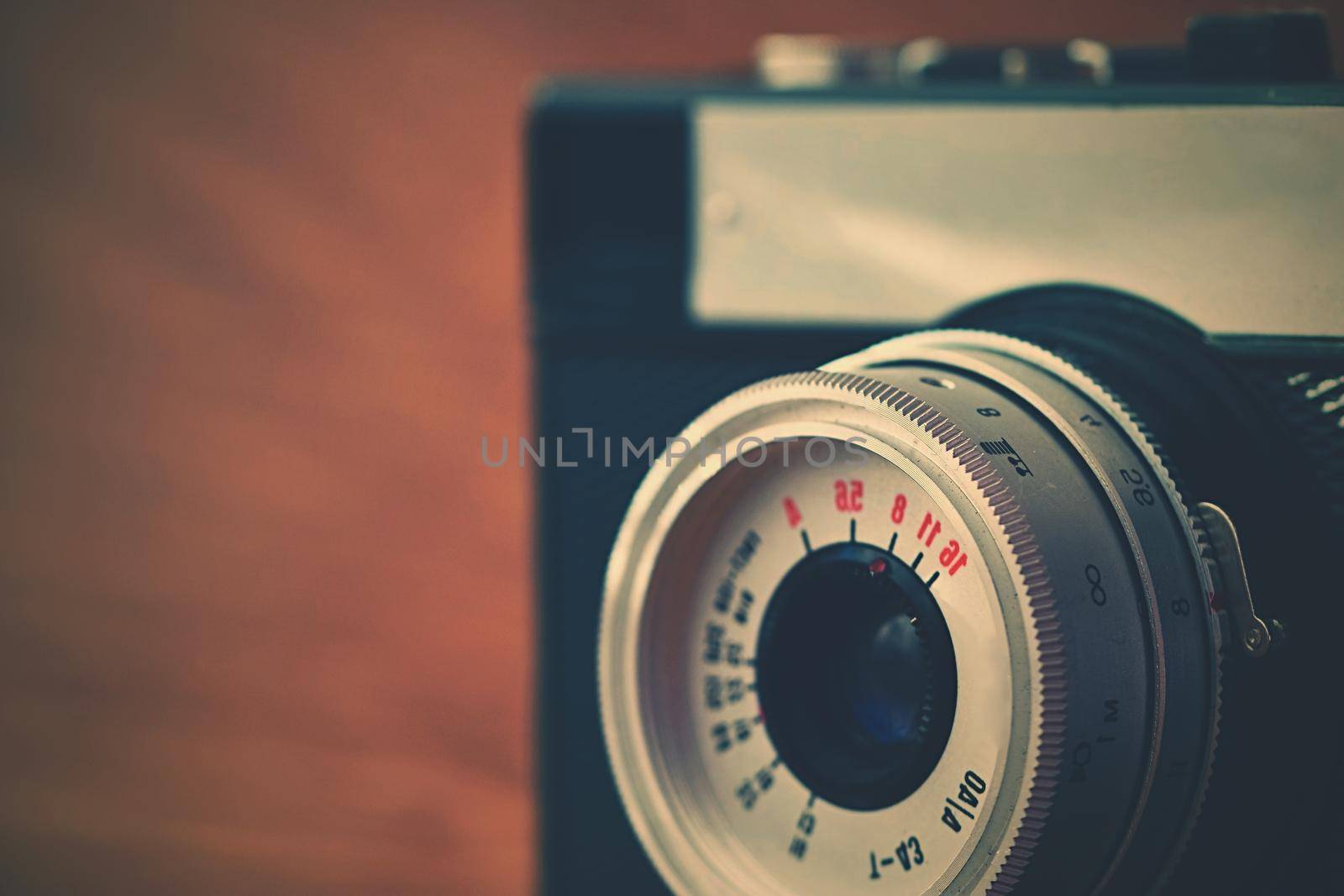 Russian old analog camera on a wooden background.