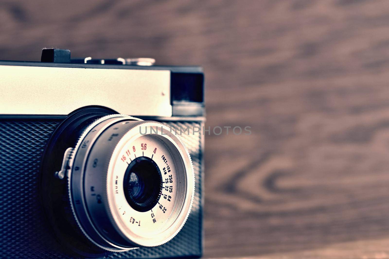 Russian old analog camera on a wooden background.