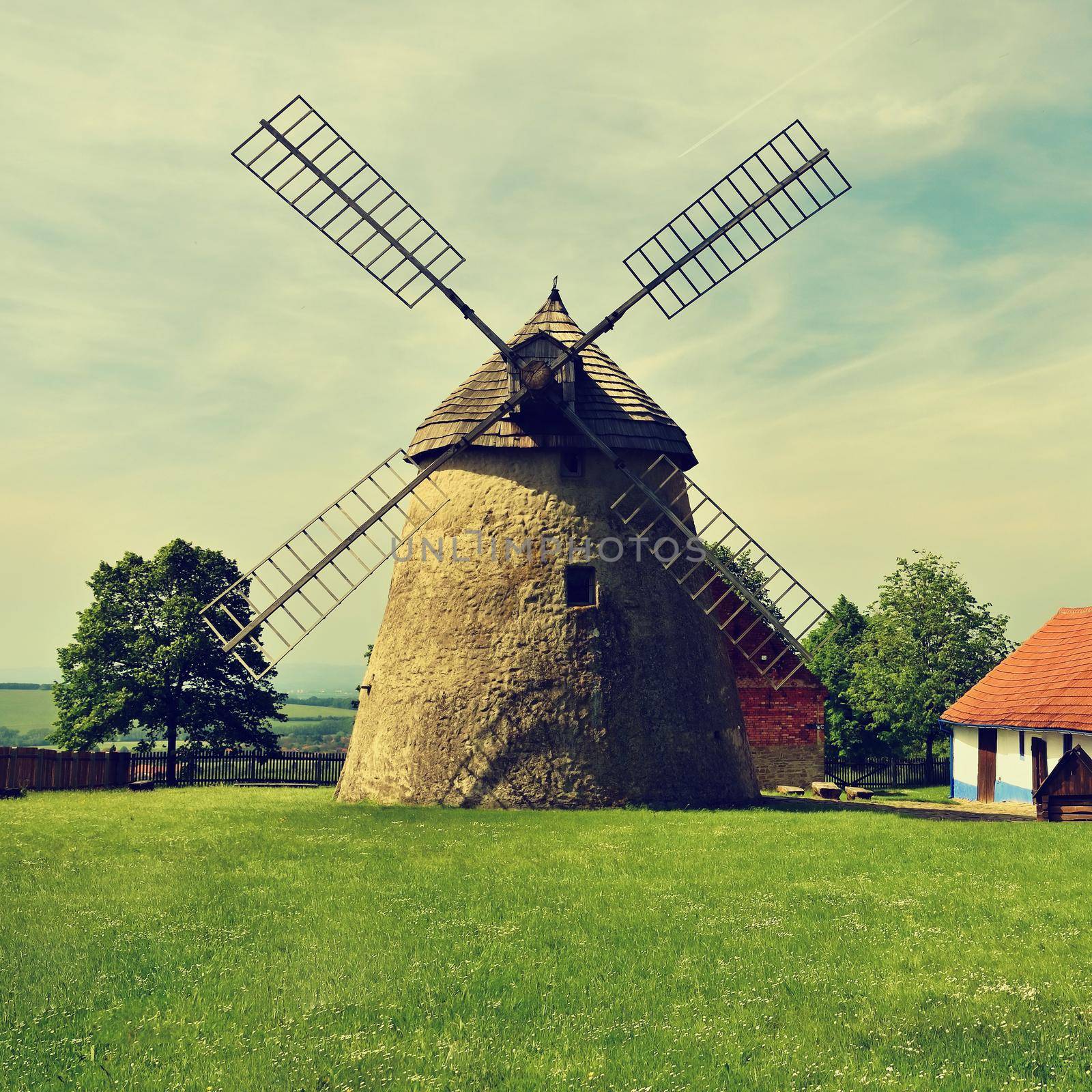 Old windmill - Czech Republic Europe. Beautiful old traditional mill house with a garden. Kuzelov - South Moravia. by Montypeter