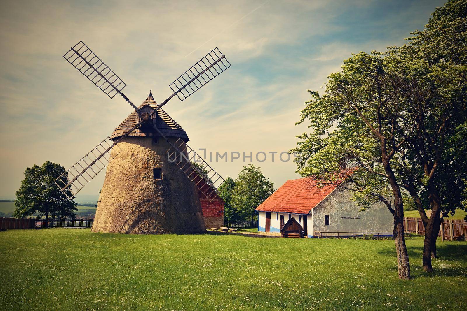 Old windmill - Czech Republic Europe. Beautiful old traditional mill house with a garden. Kuzelov - South Moravia.