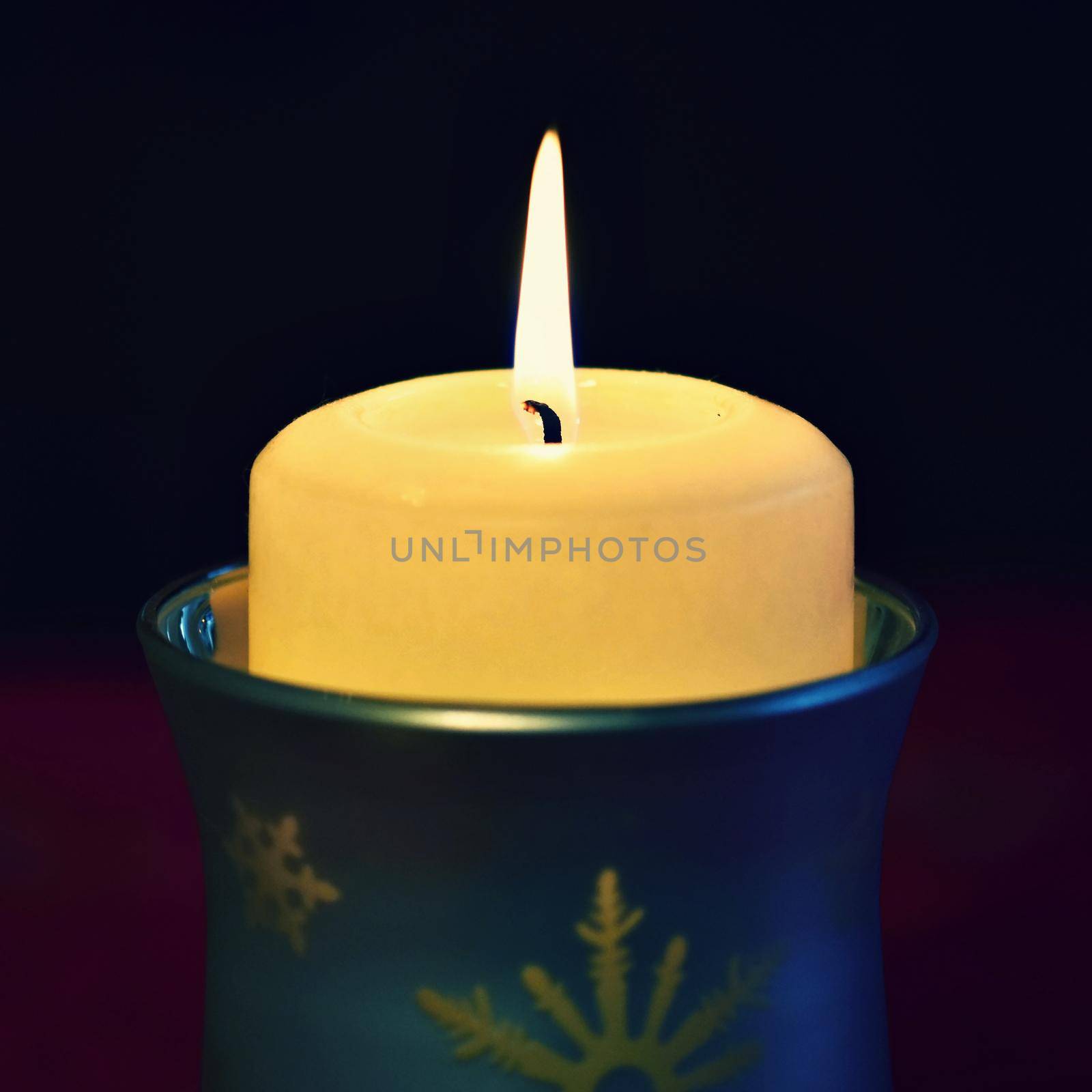 beautiful candle burning with a pure black background