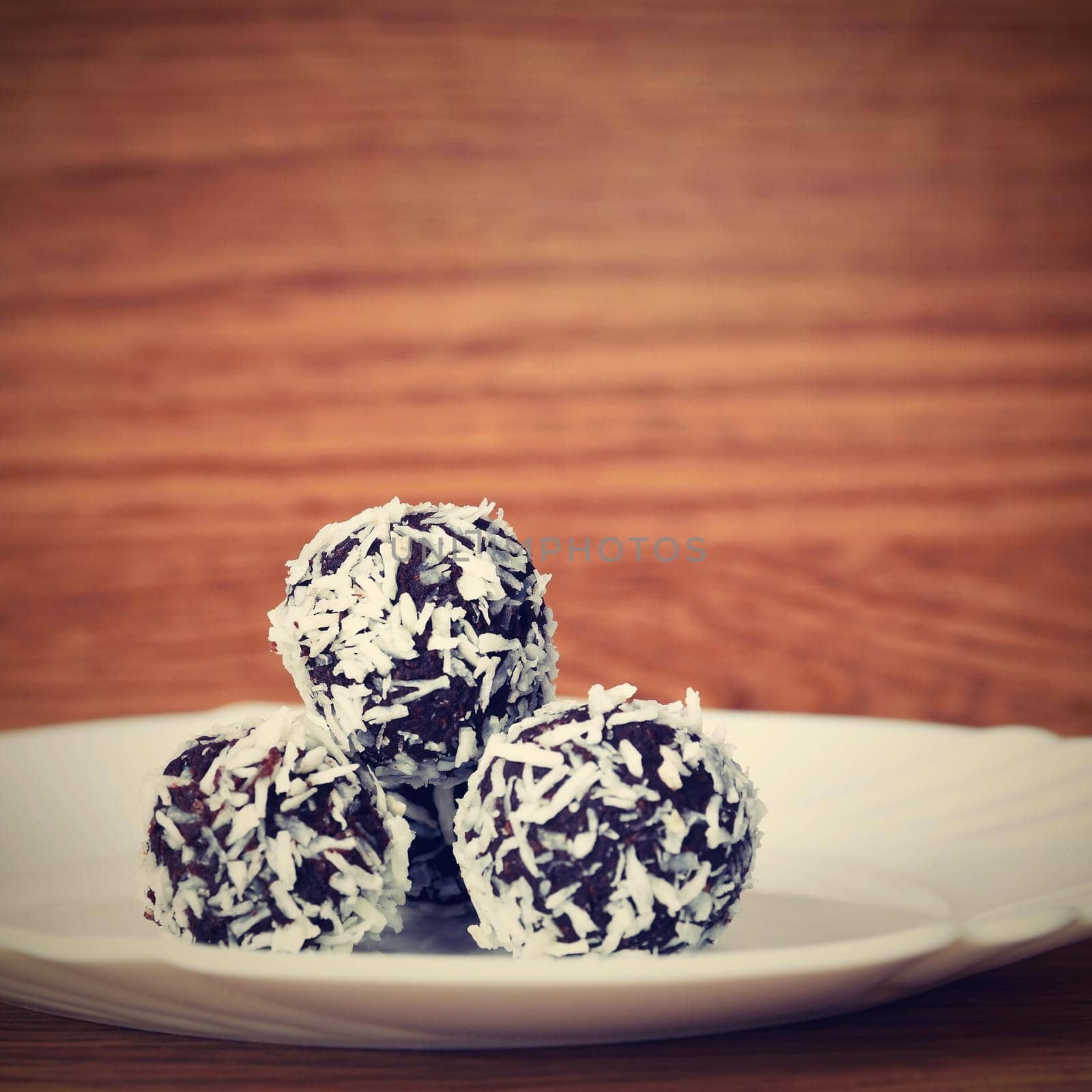 Christmas sweets on a plate - Rum balls in coconut. Traditional homemade handmade Czech sweets.