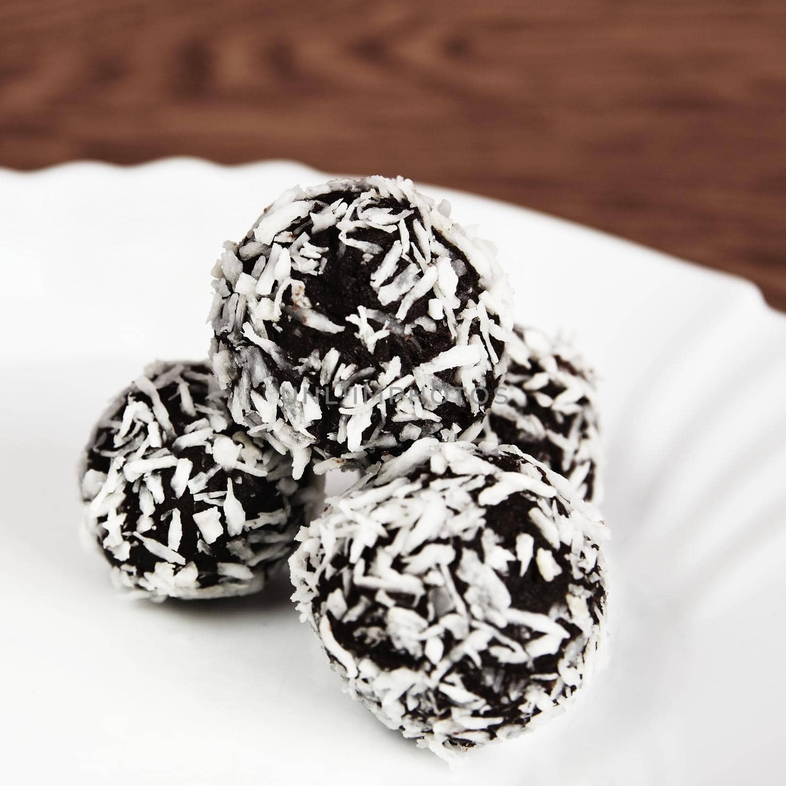 Christmas sweets on a plate - Rum balls in coconut. Traditional homemade handmade Czech sweets.