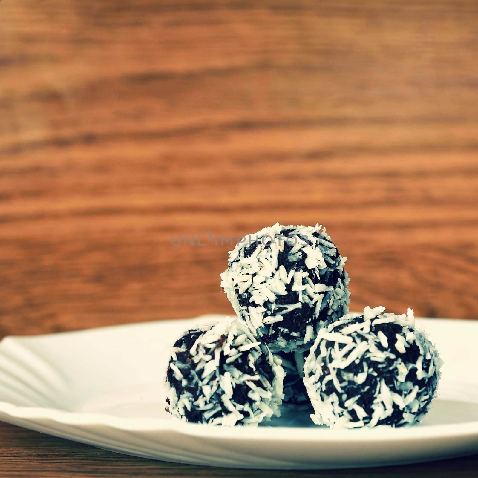 Christmas sweets on a plate - Rum balls in coconut. Traditional homemade handmade Czech sweets.