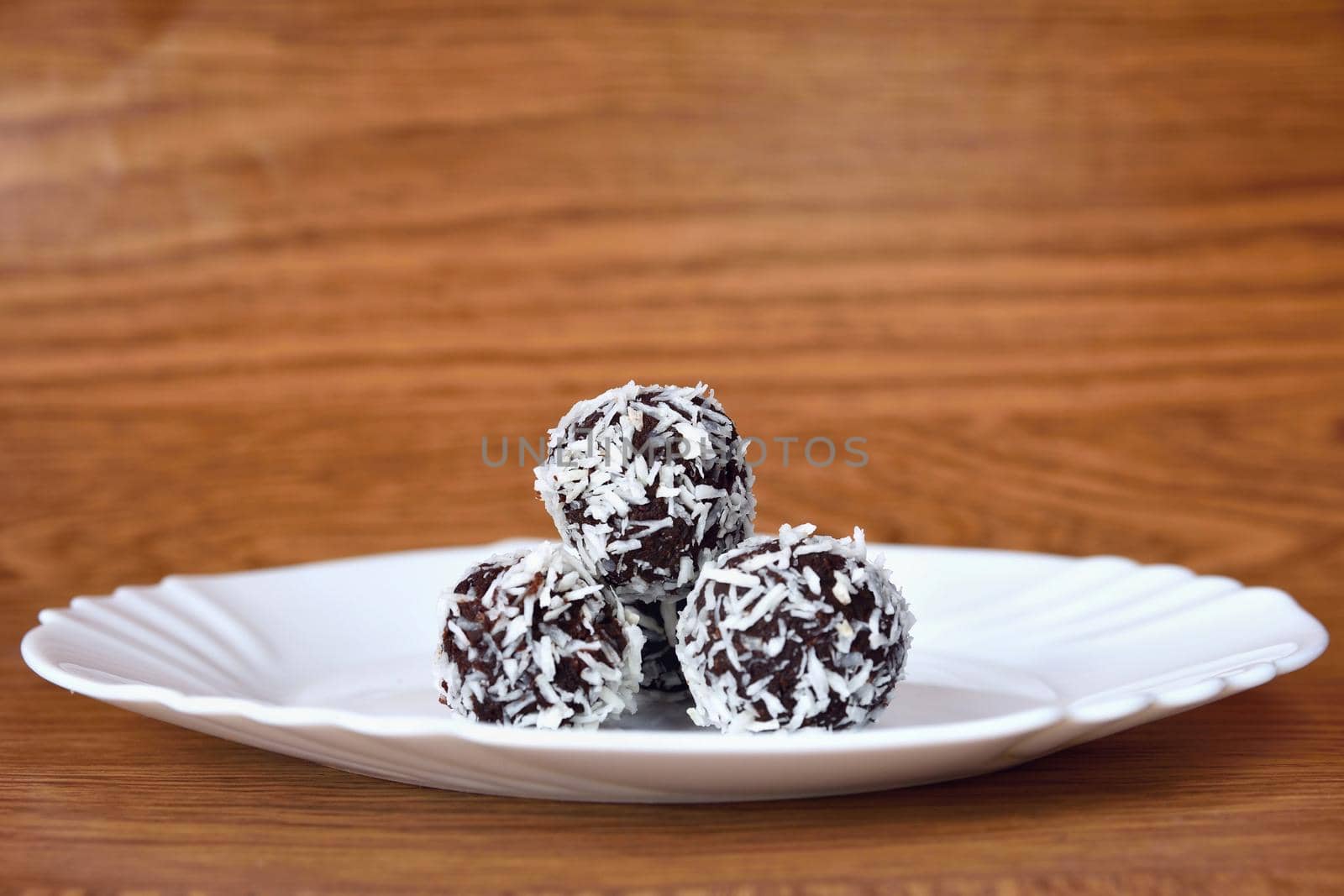 Christmas sweets on a plate - Rum balls in coconut. Traditional homemade handmade Czech sweets.
