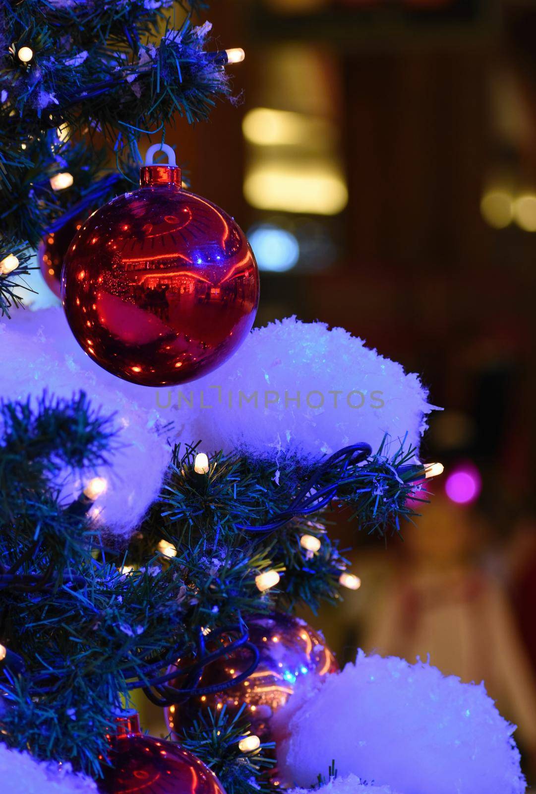 Colorful christmas Decoration. Winter holidays and traditional ornaments on a Christmas tree. Lighting chains-bulbs for seasonal background. by Montypeter