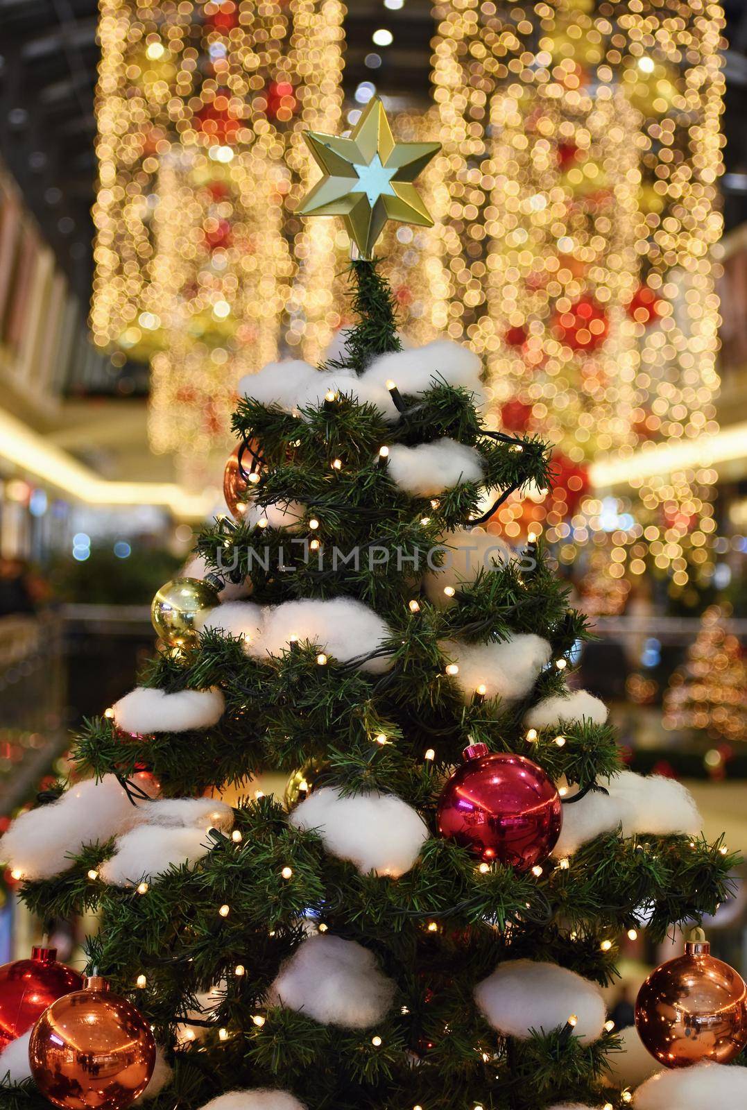 Colorful christmas Decoration. Winter holidays and traditional ornaments on a Christmas tree. Lighting chains-bulbs for seasonal background. by Montypeter